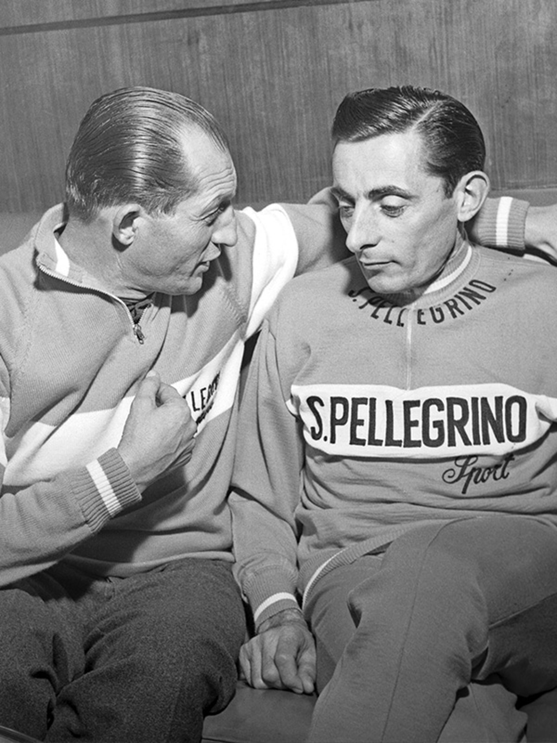 {generated} Two cyclists in S.Pellegrino jerseys sit together in a vintage setting, reflecting the legacy that inspires Breitling.