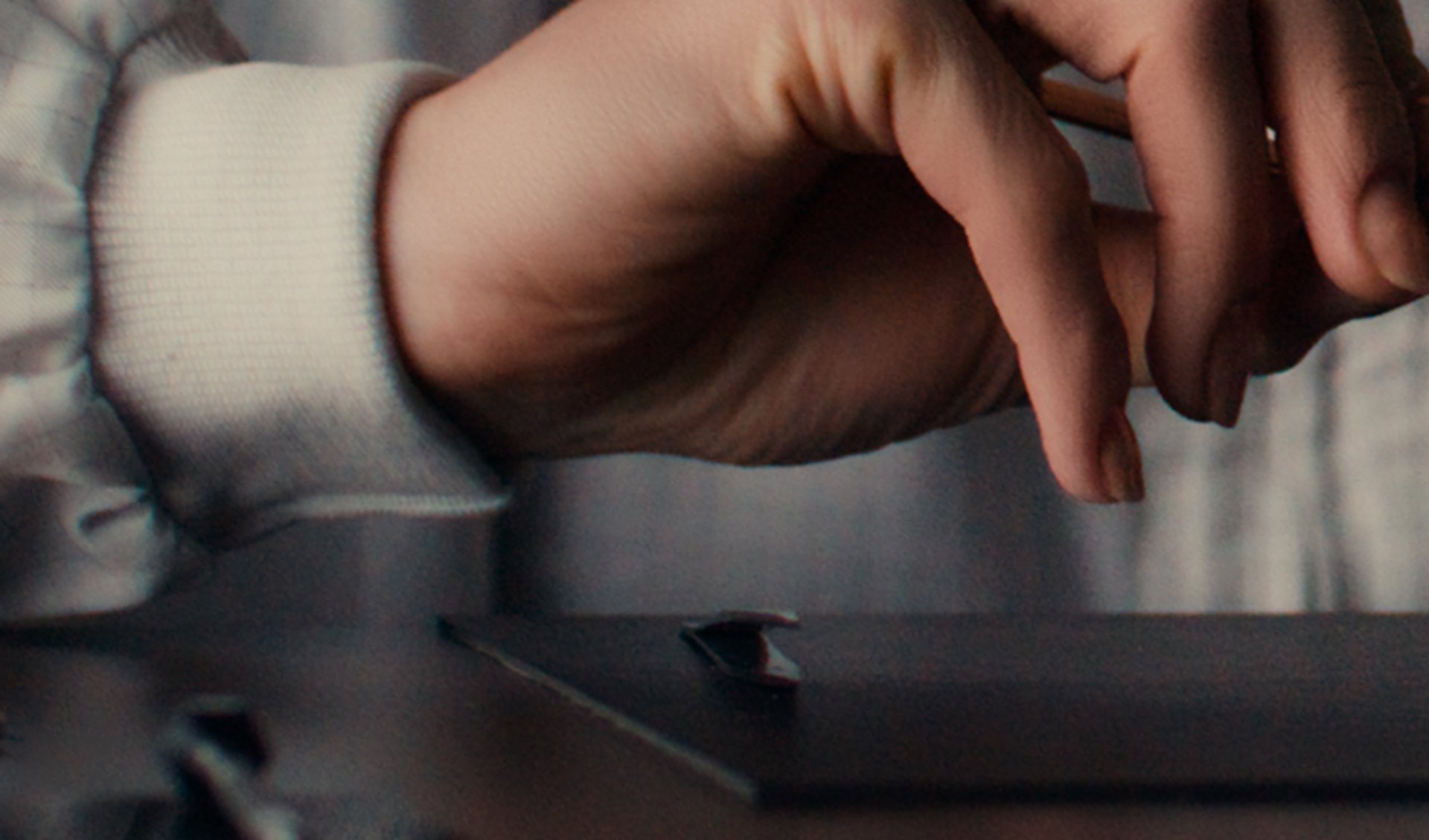 {generated} A watchmaker in a Breitling coat carefully adjusts a movement with precision tools, highlighting meticulous service work