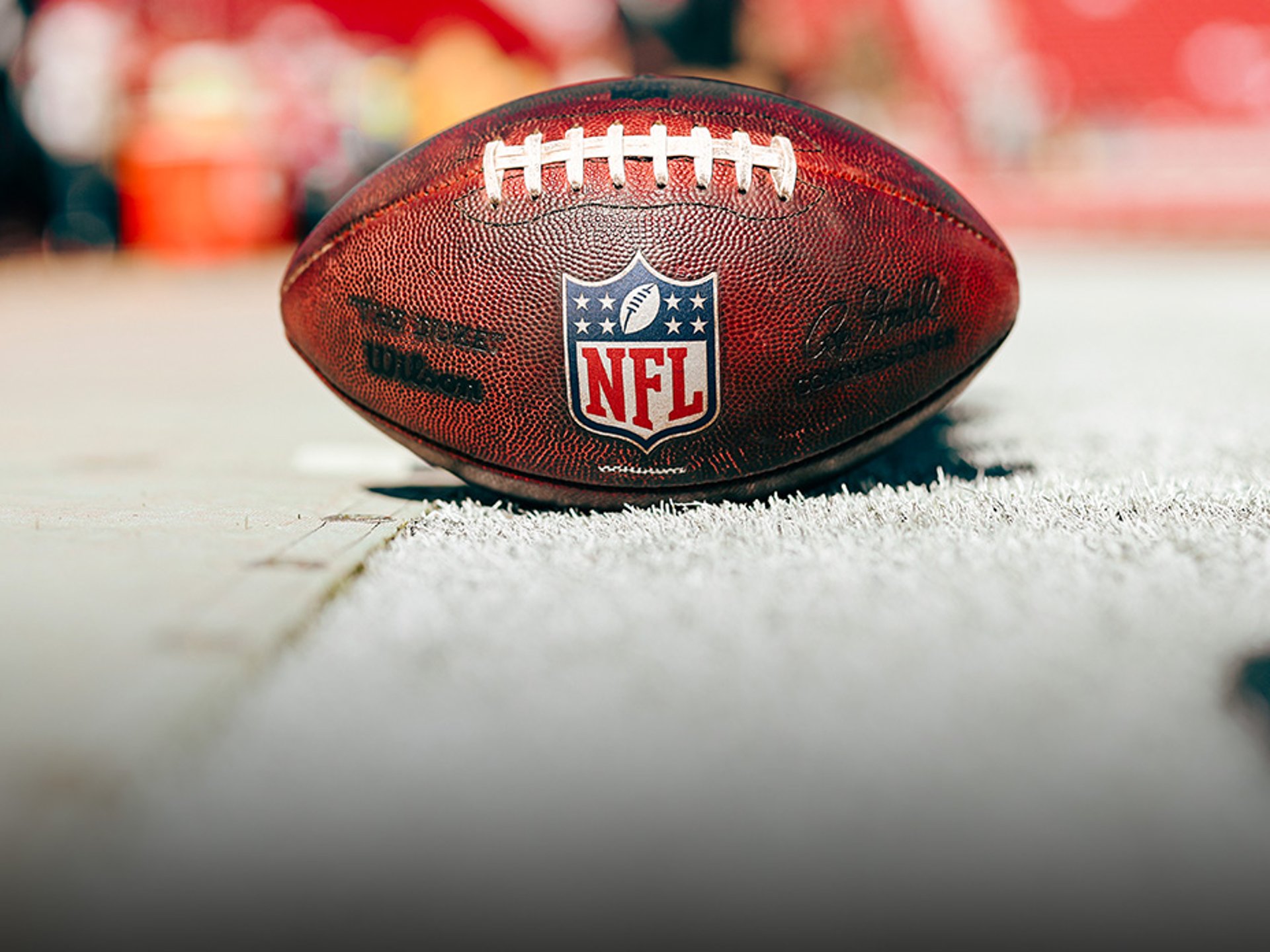 Close-up of a Breitling watch with the NFL logo on the dial