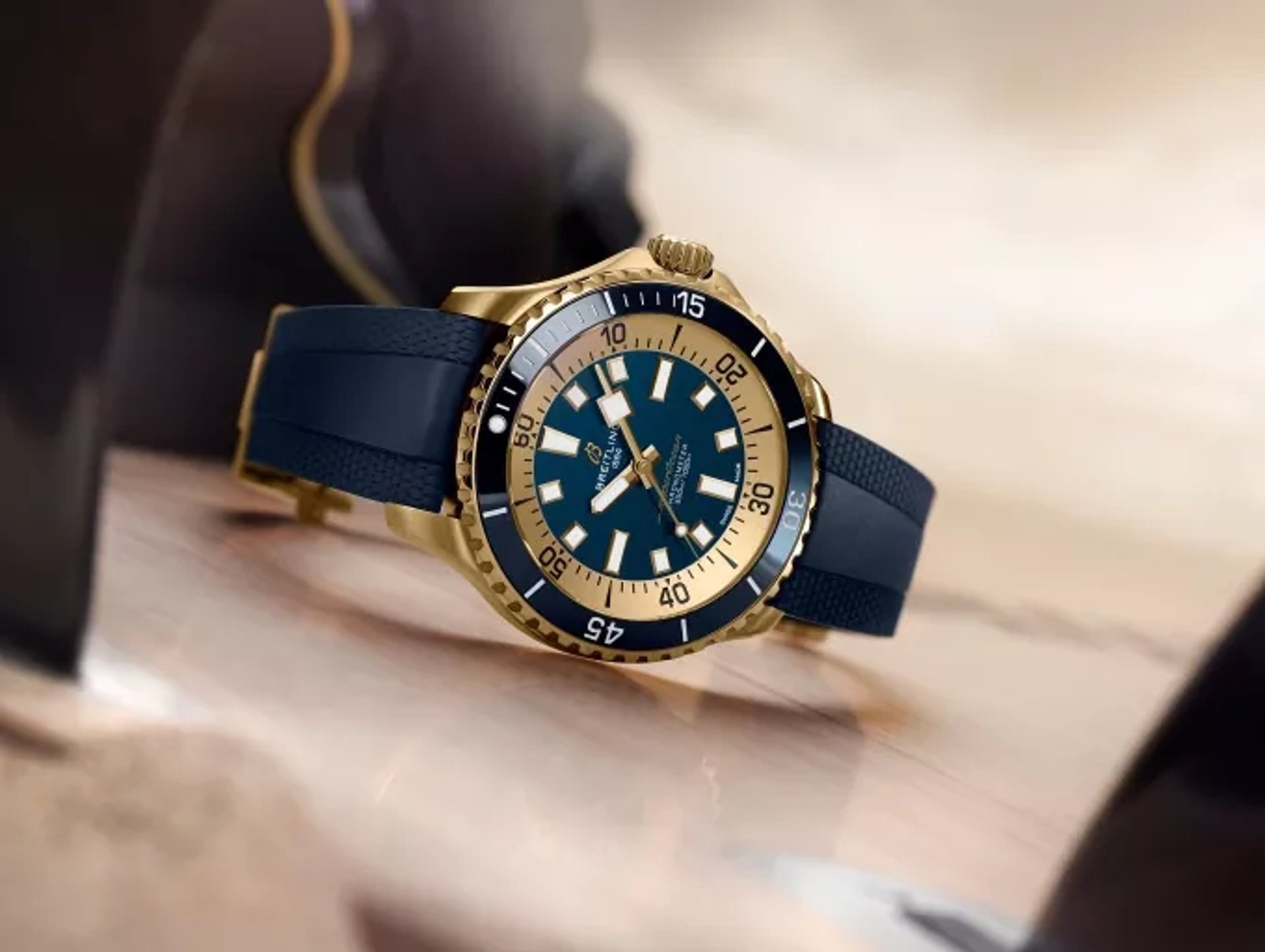 {generated} Breitling Superocean displayed on a surface with gold case, blue dial and rubber strap highlighting its refined design