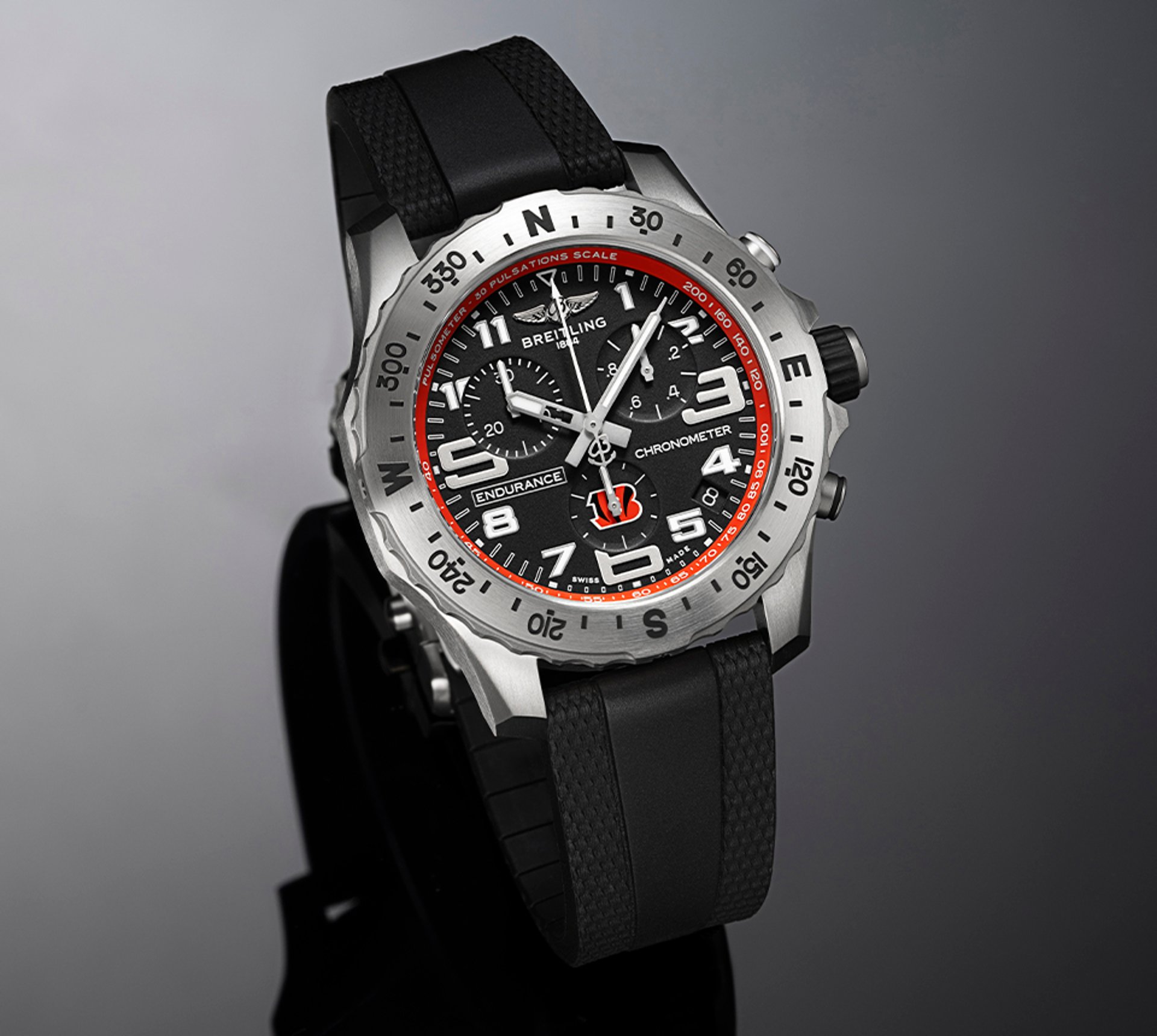 {generated} Breitling Endurance Pro watch with black dial, orange Bengals accents, and black strap presented in a sleek studio setting