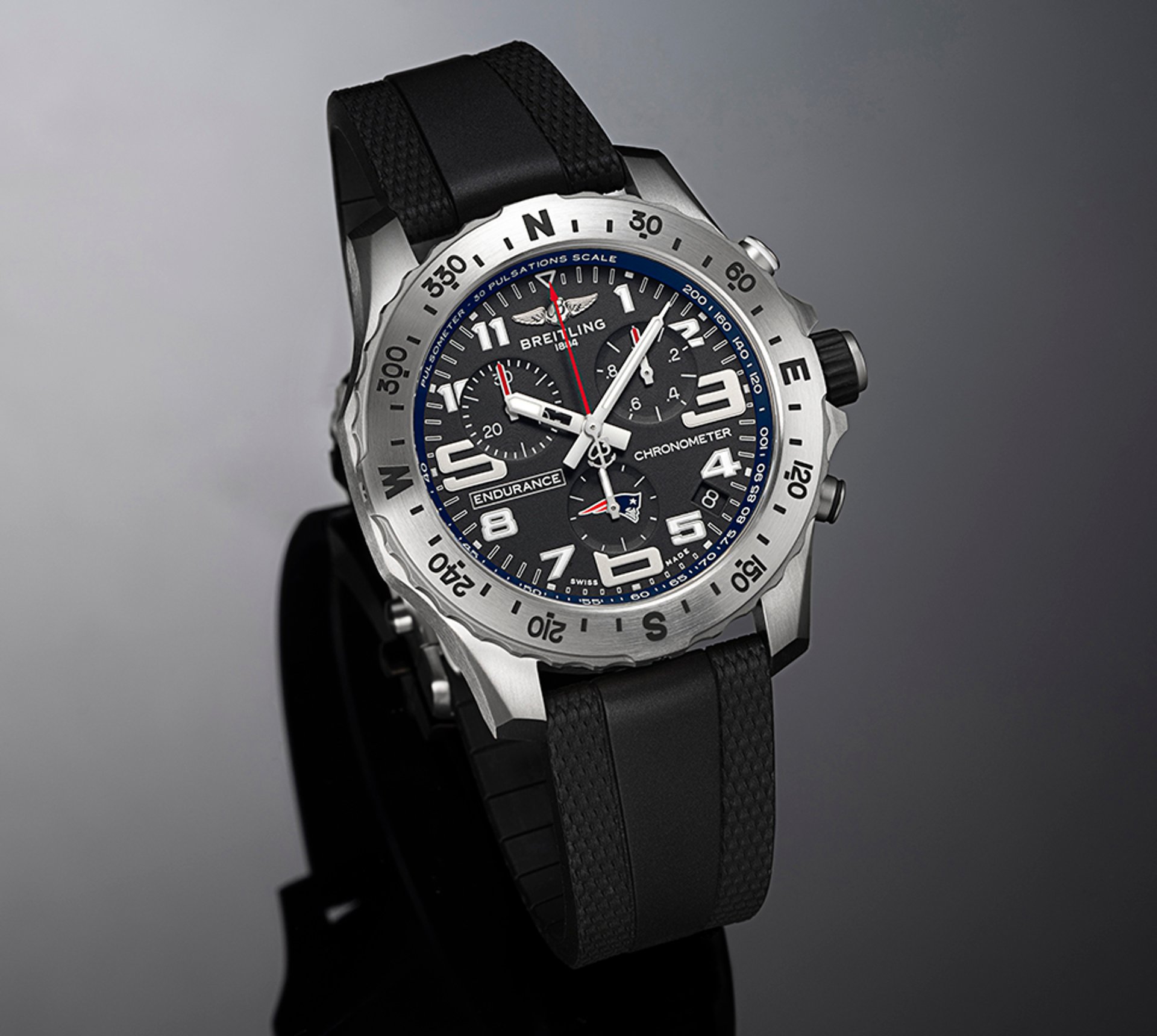 {generated} Breitling Endurance Pro watch with Patriots accents, featuring a black dial, bold numerals, and a black rubber strap.