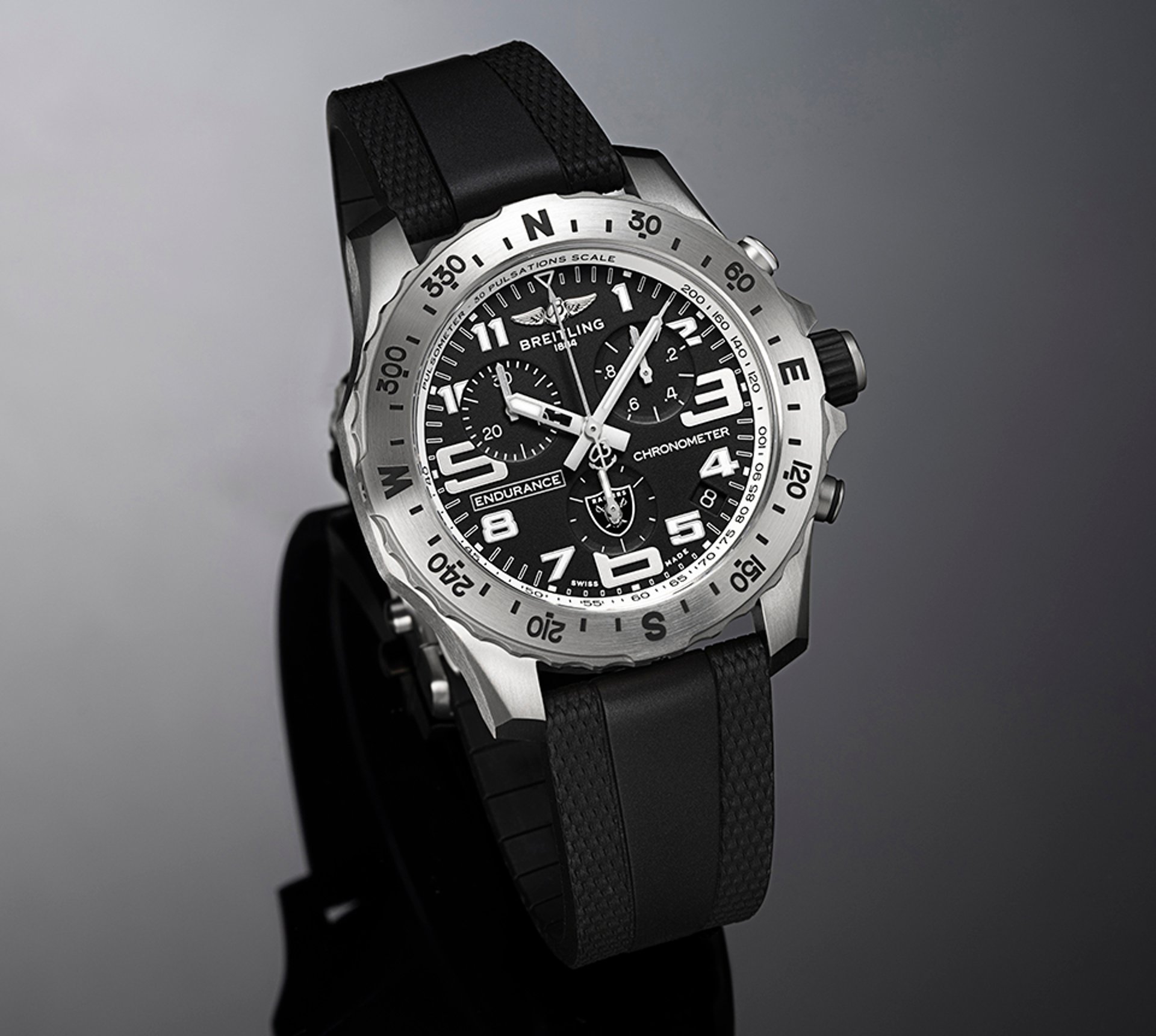 {generated} Breitling Endurance chronometer with black dial, Raiders emblem and rubber strap presented in a sleek studio view