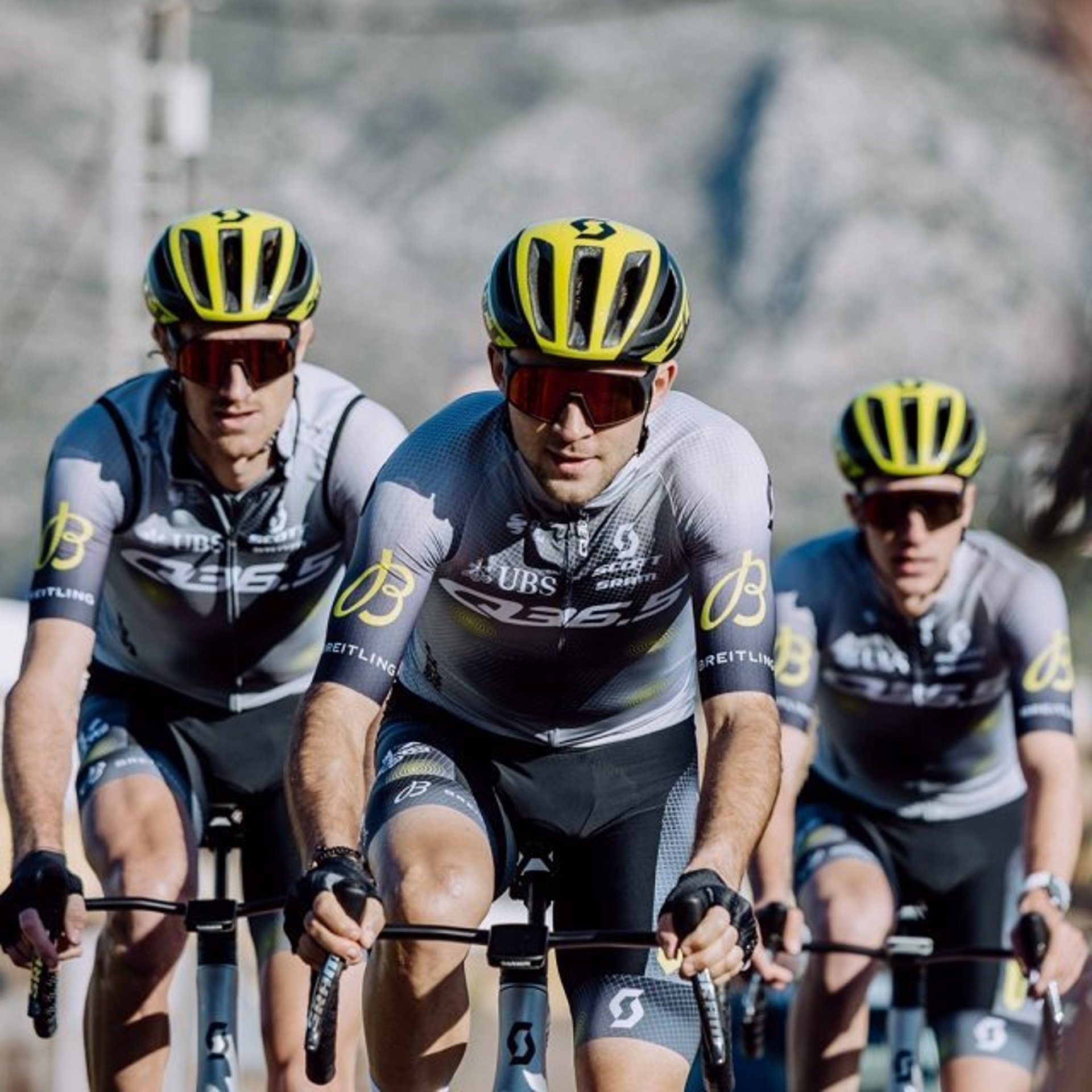 {generated} Cyclists in Breitling-branded kits ride in tight formation toward a world tour, expressing focused athletic energy and precision.