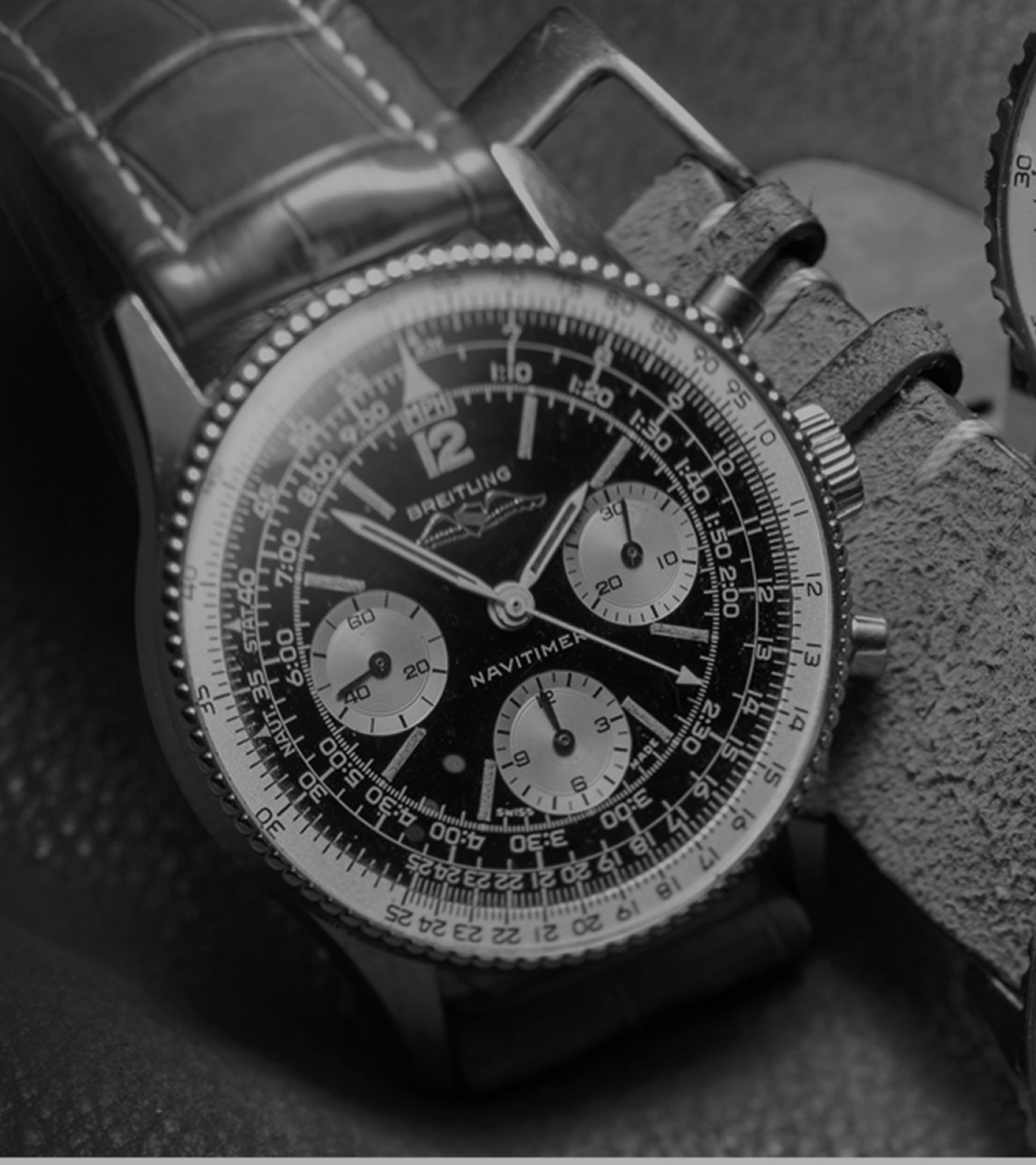 {generated} Three vintage Breitling Navitimer watches shown in a detailed close-up highlighting their black dials and classic chronograph design