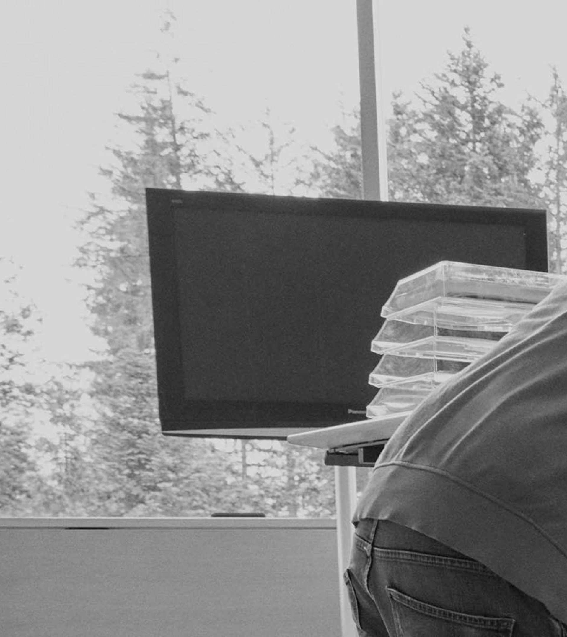 {generated} Engineers examine intricate digital schematics across several screens within a bright Breitling research and development space