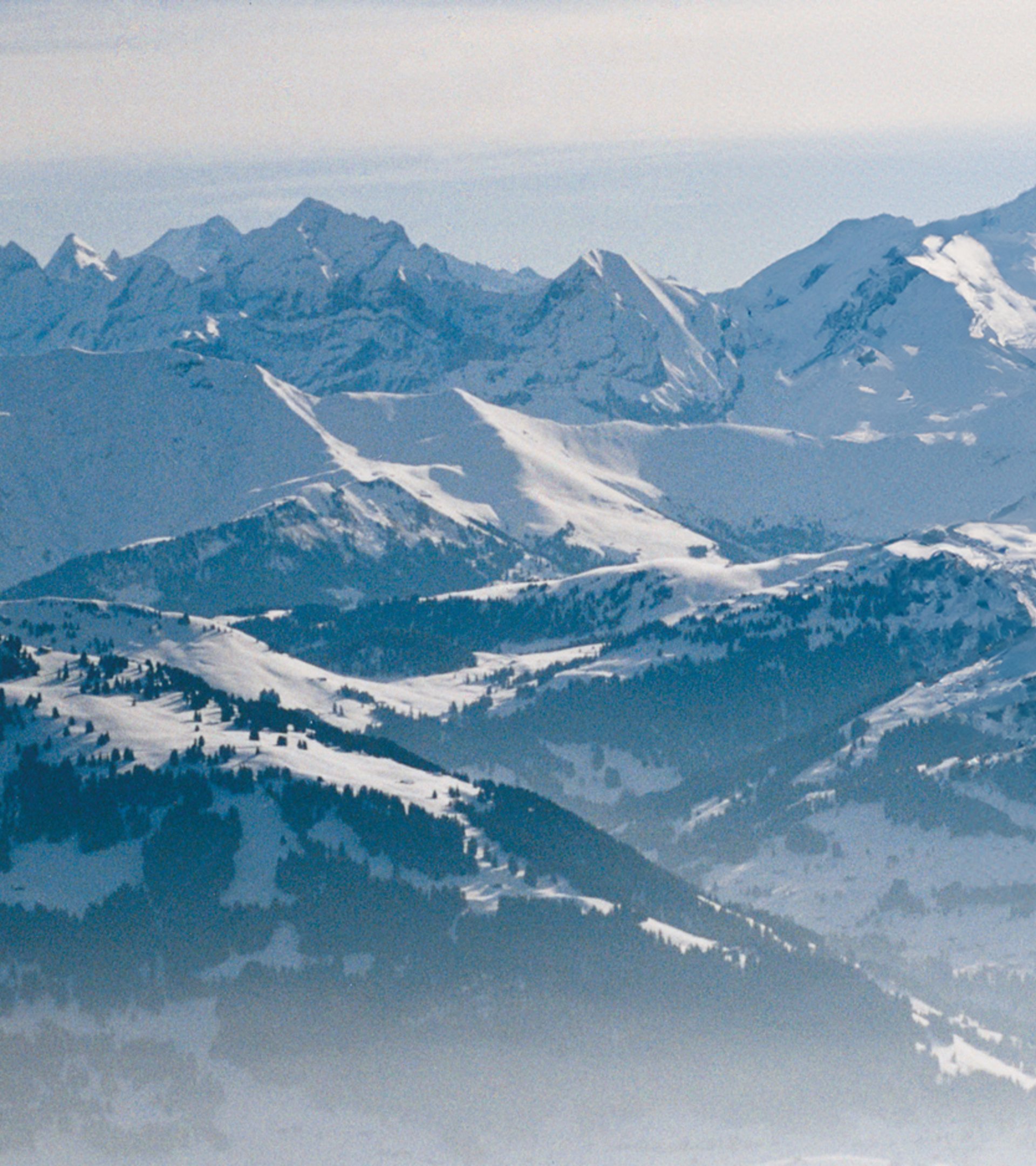 {generated} Breitling Orbiter 3 hot-air balloon gliding above expansive snowy mountain peaks, highlighting adventurous spirit.