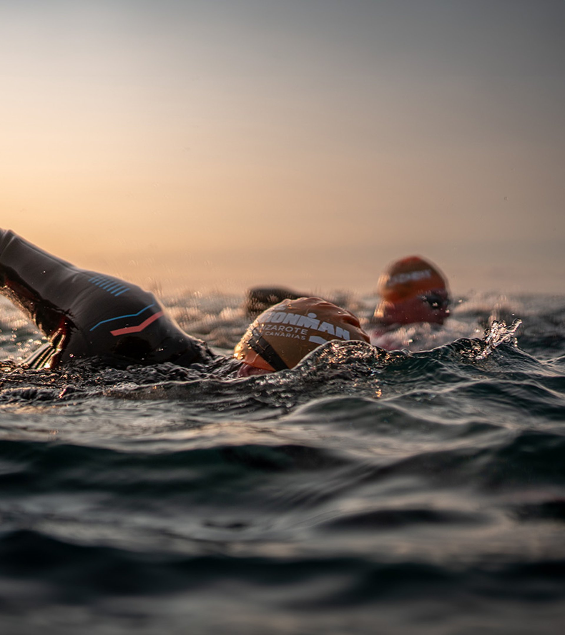 Two Ironman athletes, symbolising the partnership between Breitling and Ironman, jump into the water.
