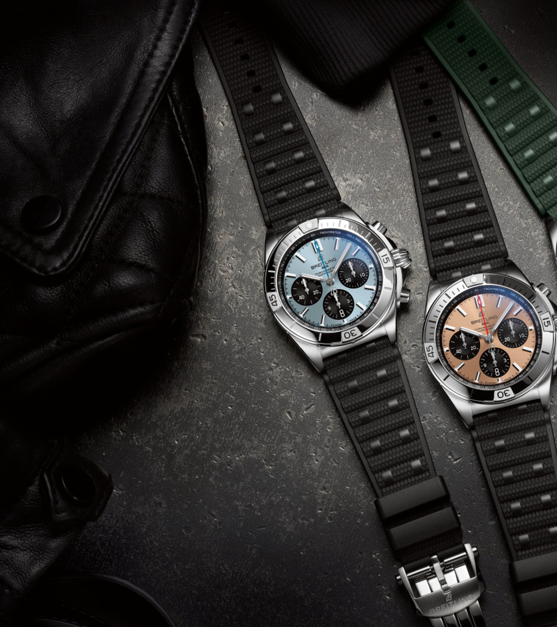 {generated} Breitling Chronomat new variants showcased with blue, bronze, and green dials on textured straps against dark surfaces