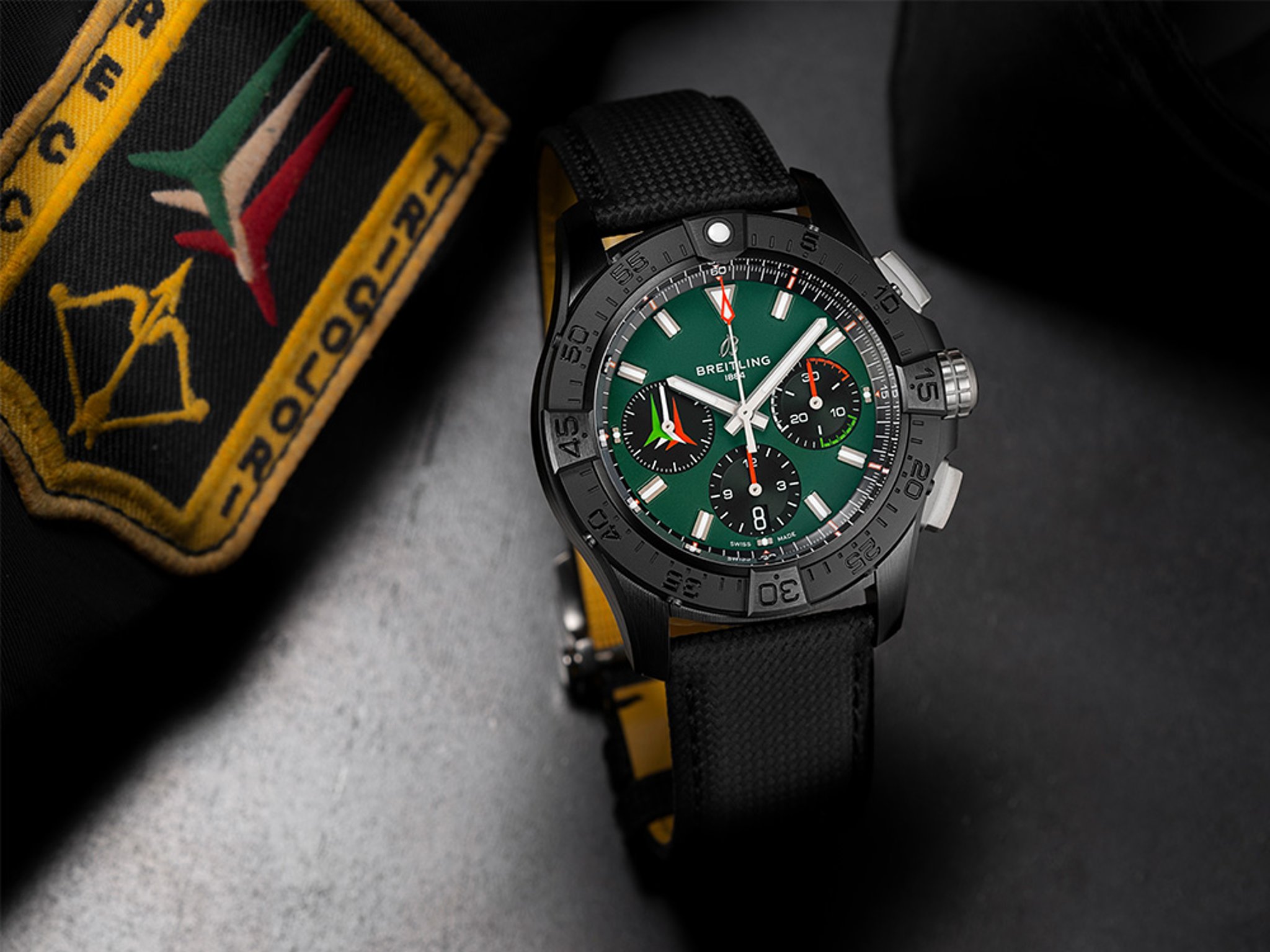 {generated} Breitling Avenger Frecce Tricolori watch with green dial and black strap set beside embroidered aviation patch
