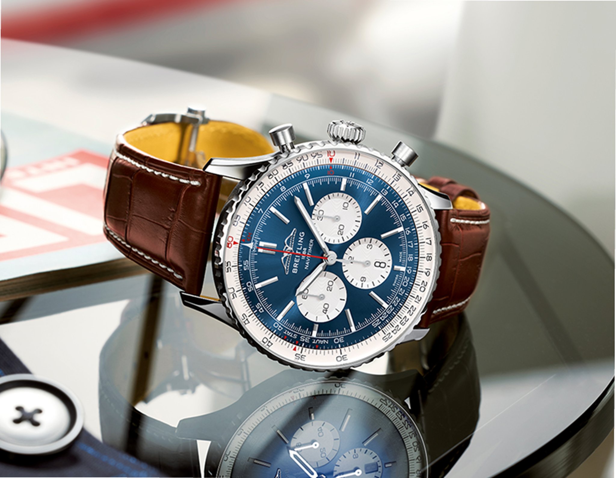 {generated} Breitling Navitimer shown with blue dial and brown leather strap resting on a glossy surface with its reflection visible