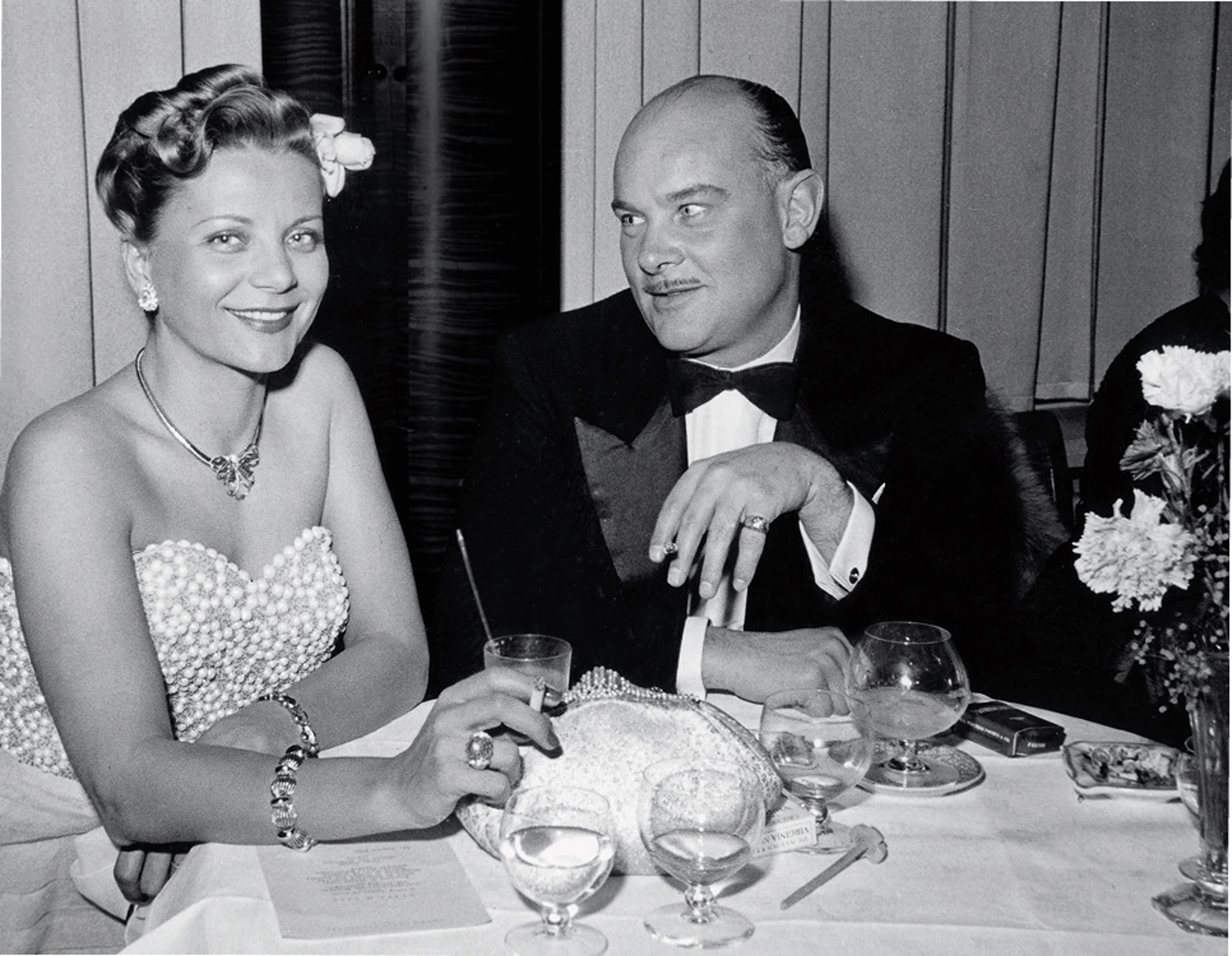 {generated} Elegant couple at a vintage dinner table, reflecting refined style and the timeless sophistication of Breitling Premier.