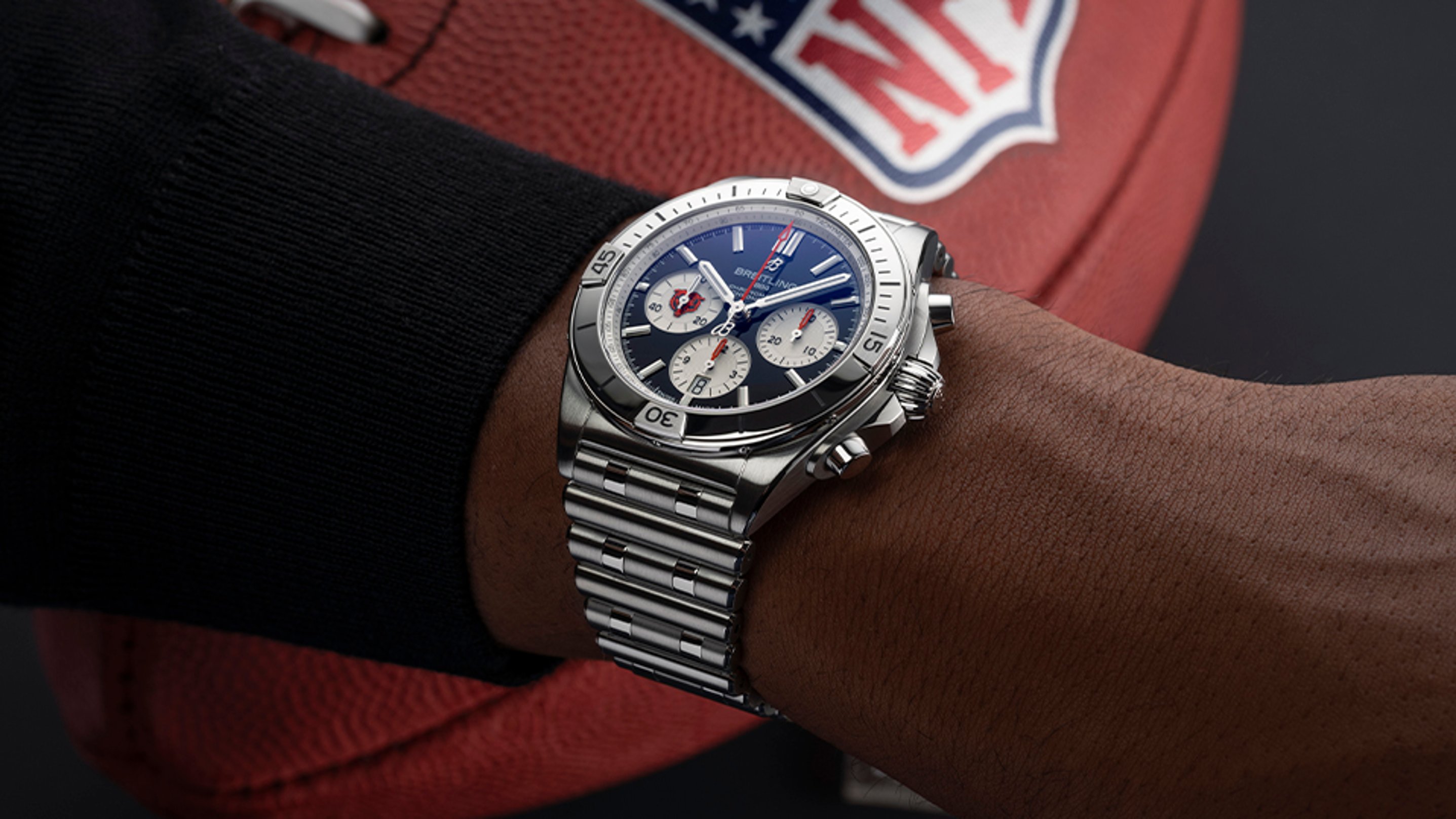 {generated} Breitling Chronomat with blue dial and steel bracelet worn near a Chicago Bears NFL football for team-themed styling