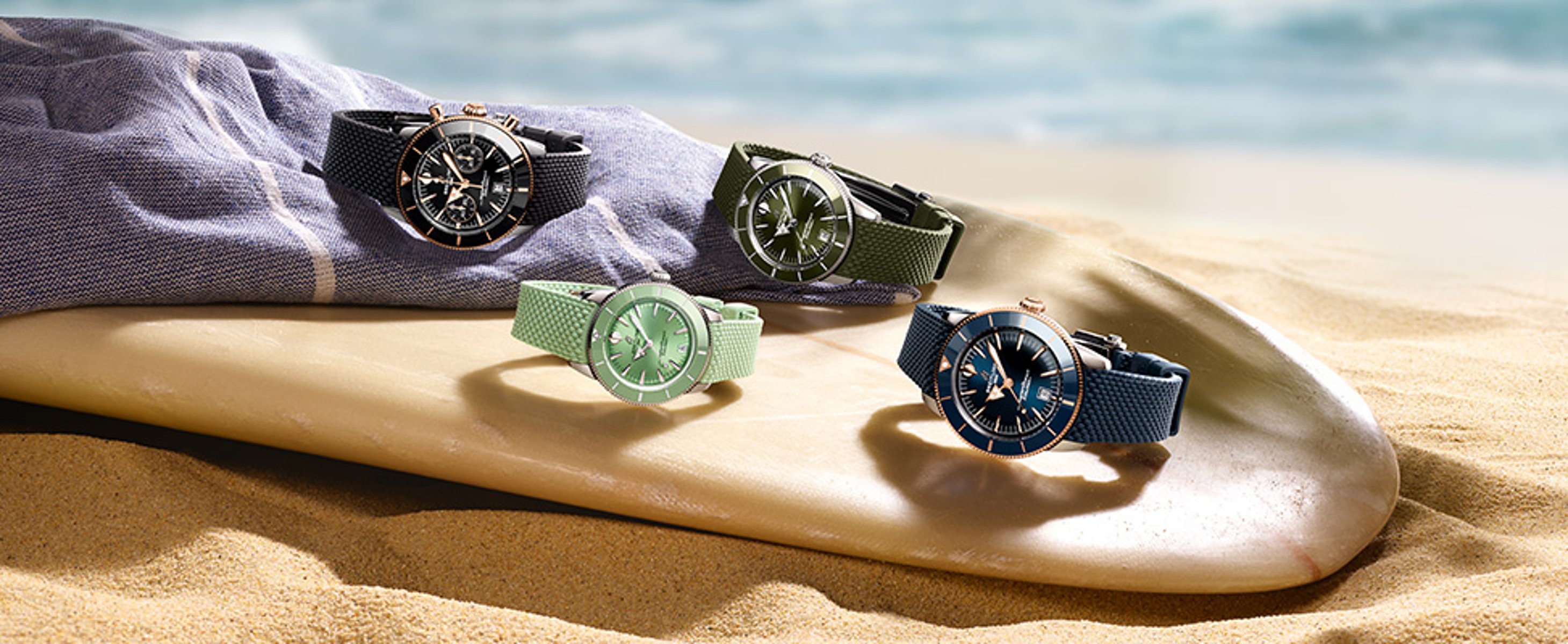 {generated} Breitling Superocean C&G watches displayed on a sunlit beach setting, highlighting colourful straps near the ocean.