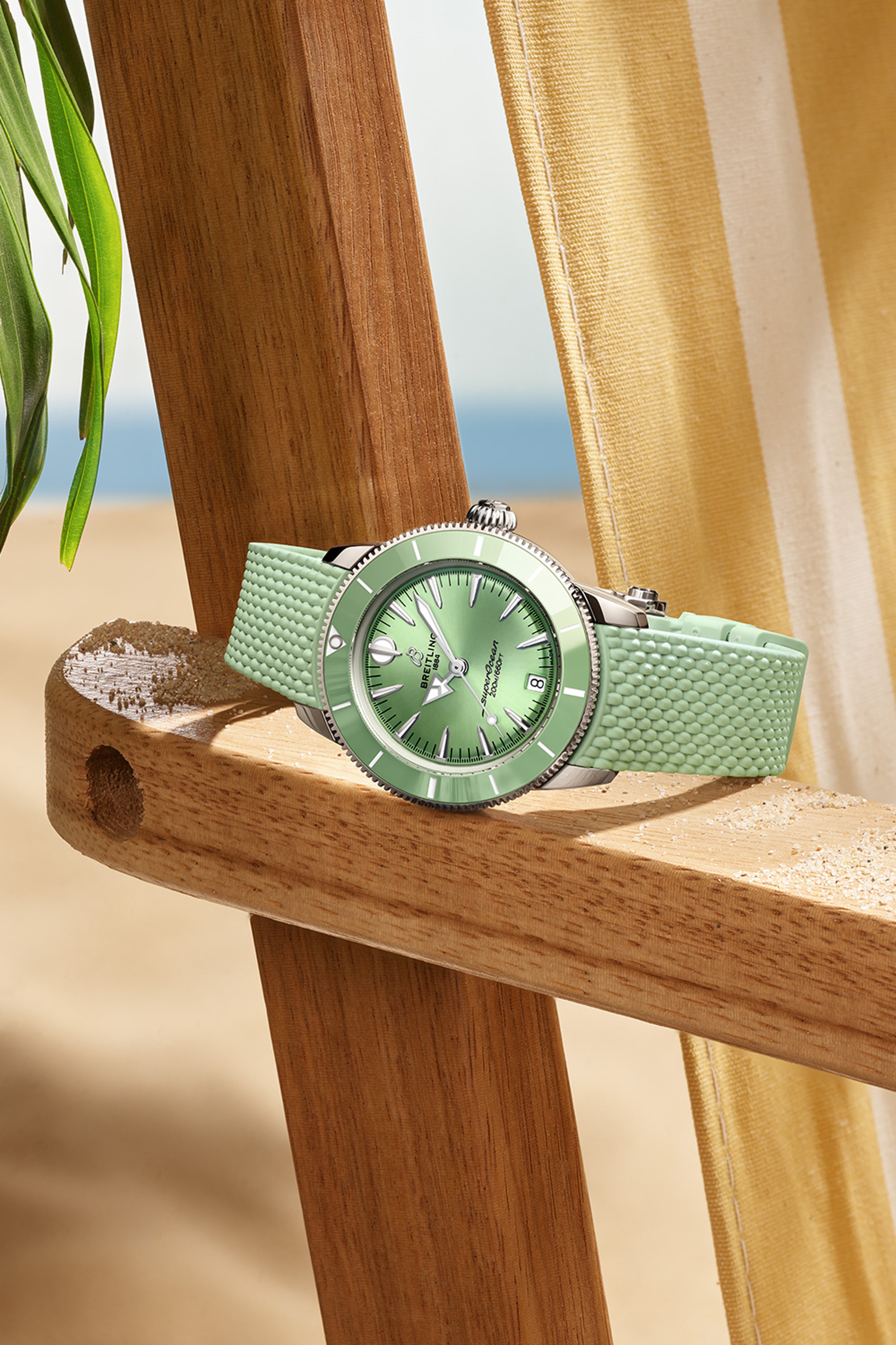 Four different colored Superocean Heritage watches lie on a brown cloth.