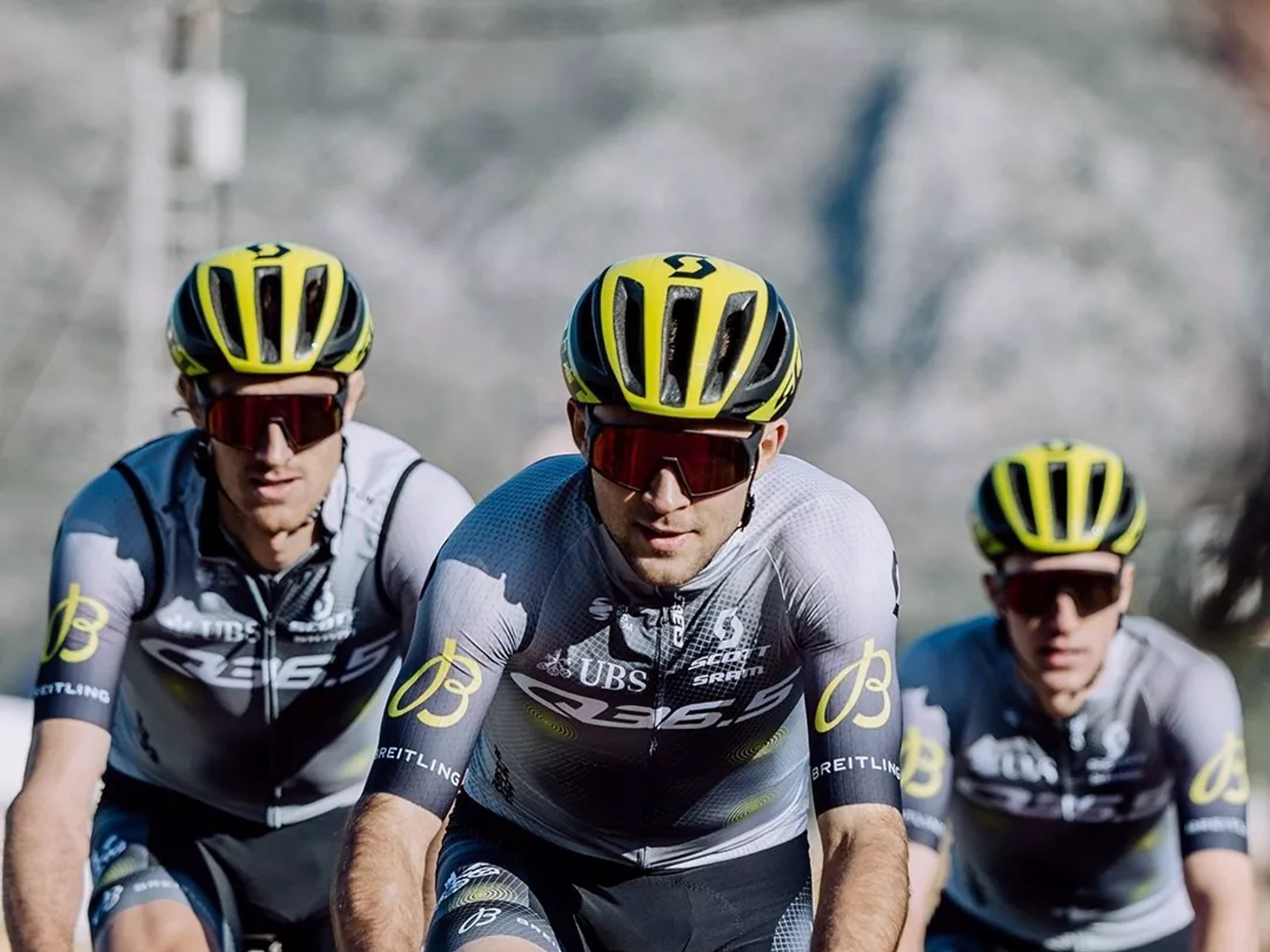Racers of the Q36.5 PRO CYCLING TEAM wear jerseys with the Breitling logo on their rides.