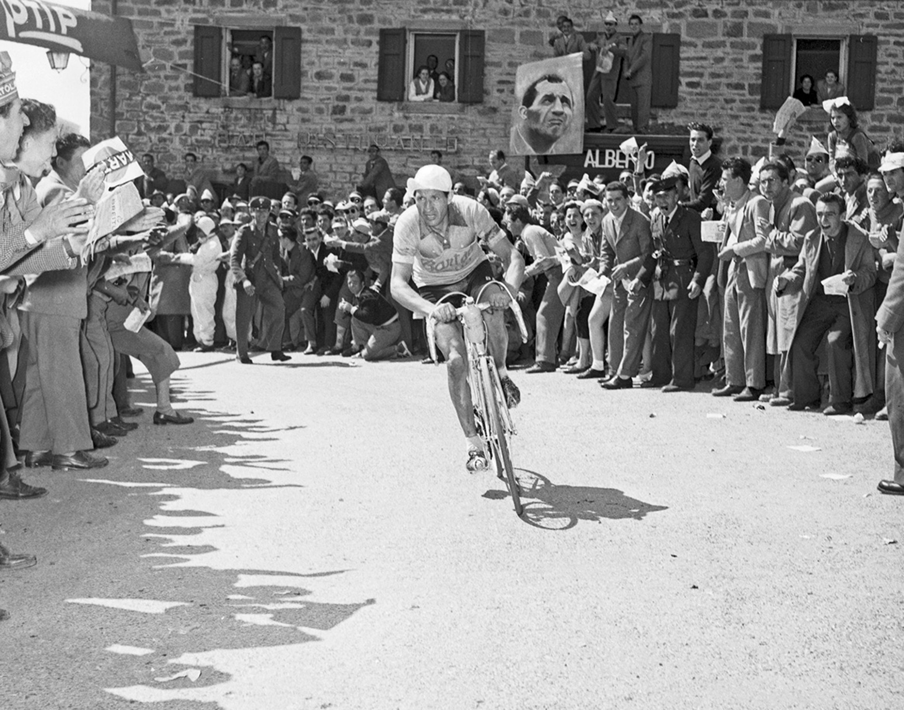 {generated} Historic cycling scene with a racer pushing forward through cheering crowds, reflecting the Bartali theme story
