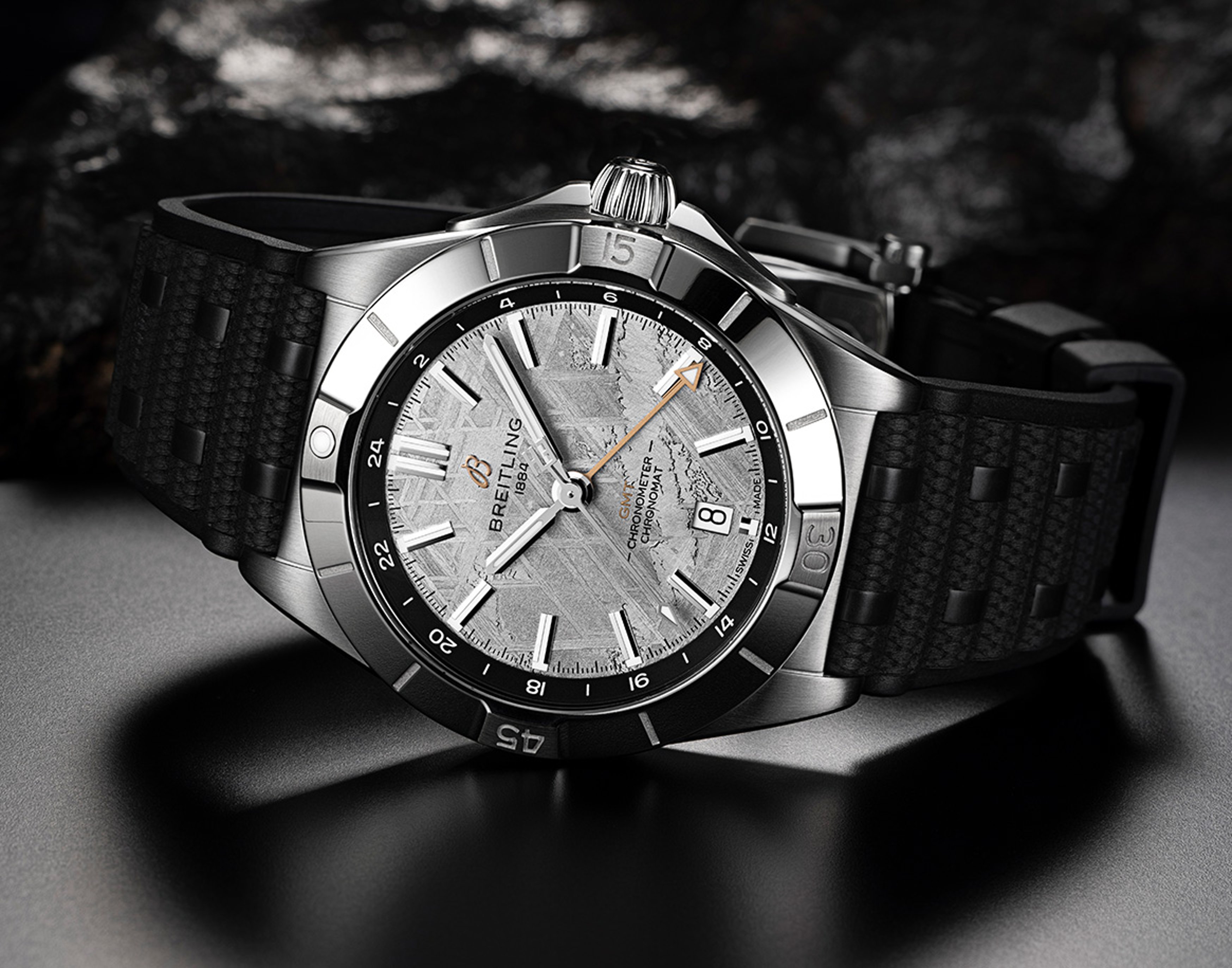 {generated} Breitling Chronomat watch with meteorite dial and black textured strap presented in a dramatic close-up product setting