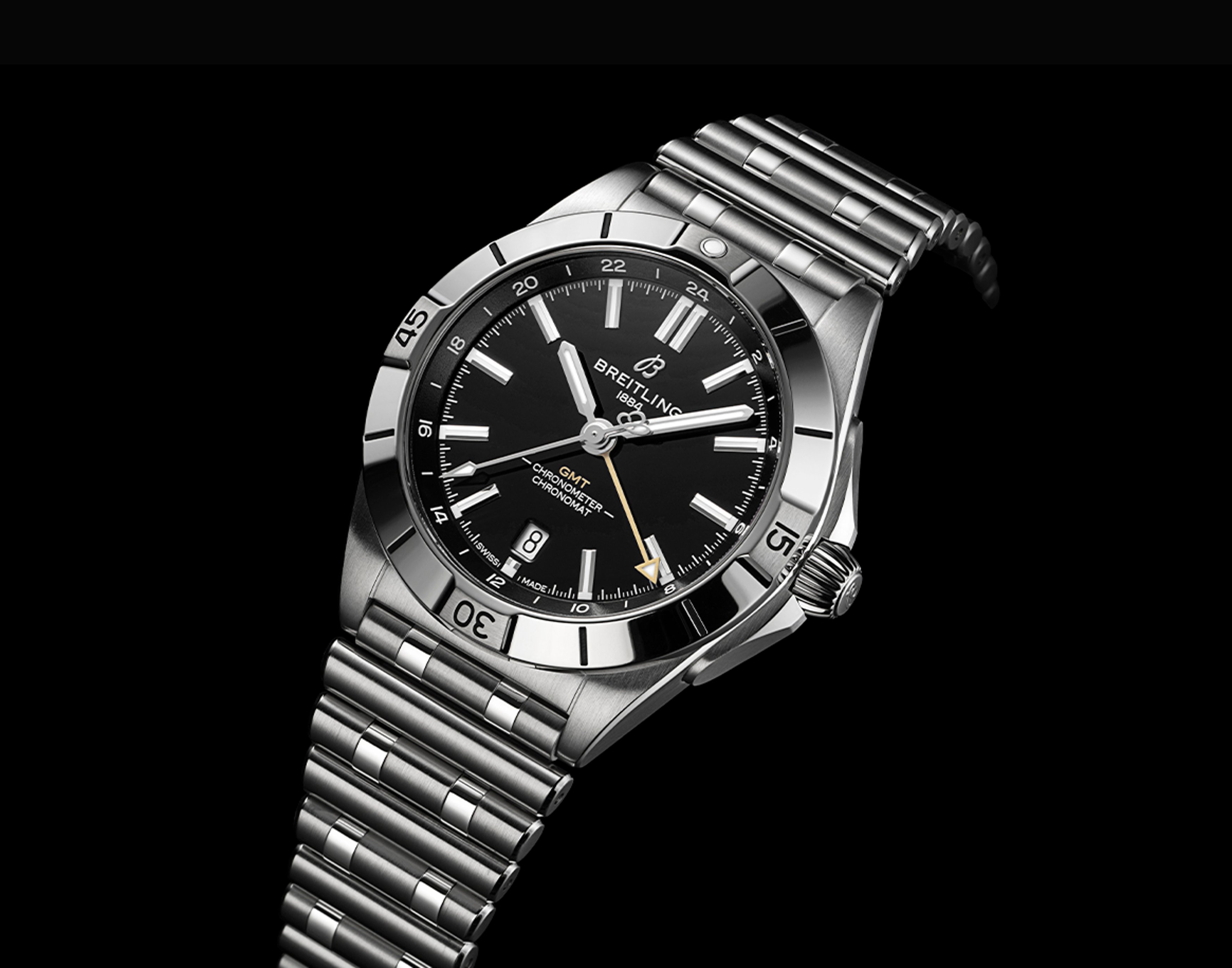 {generated} Breitling Chronomat GMT with black dial and steel bracelet presented against black backdrop, linked to New Orleans Saints.