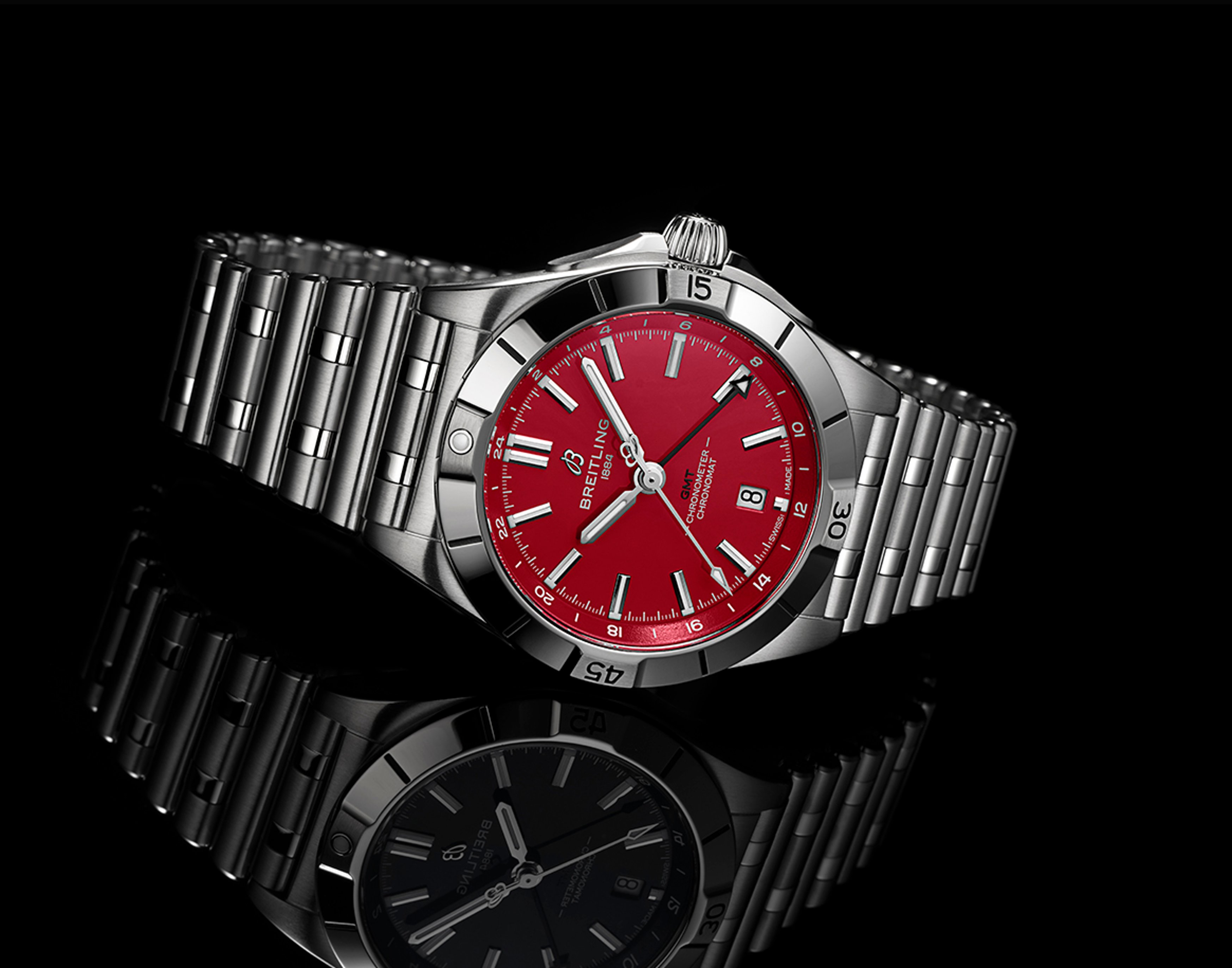 {generated} Breitling Chronomat with a vivid red Tampa Bay Buccaneers dial shown on a polished steel bracelet against a dark backdrop