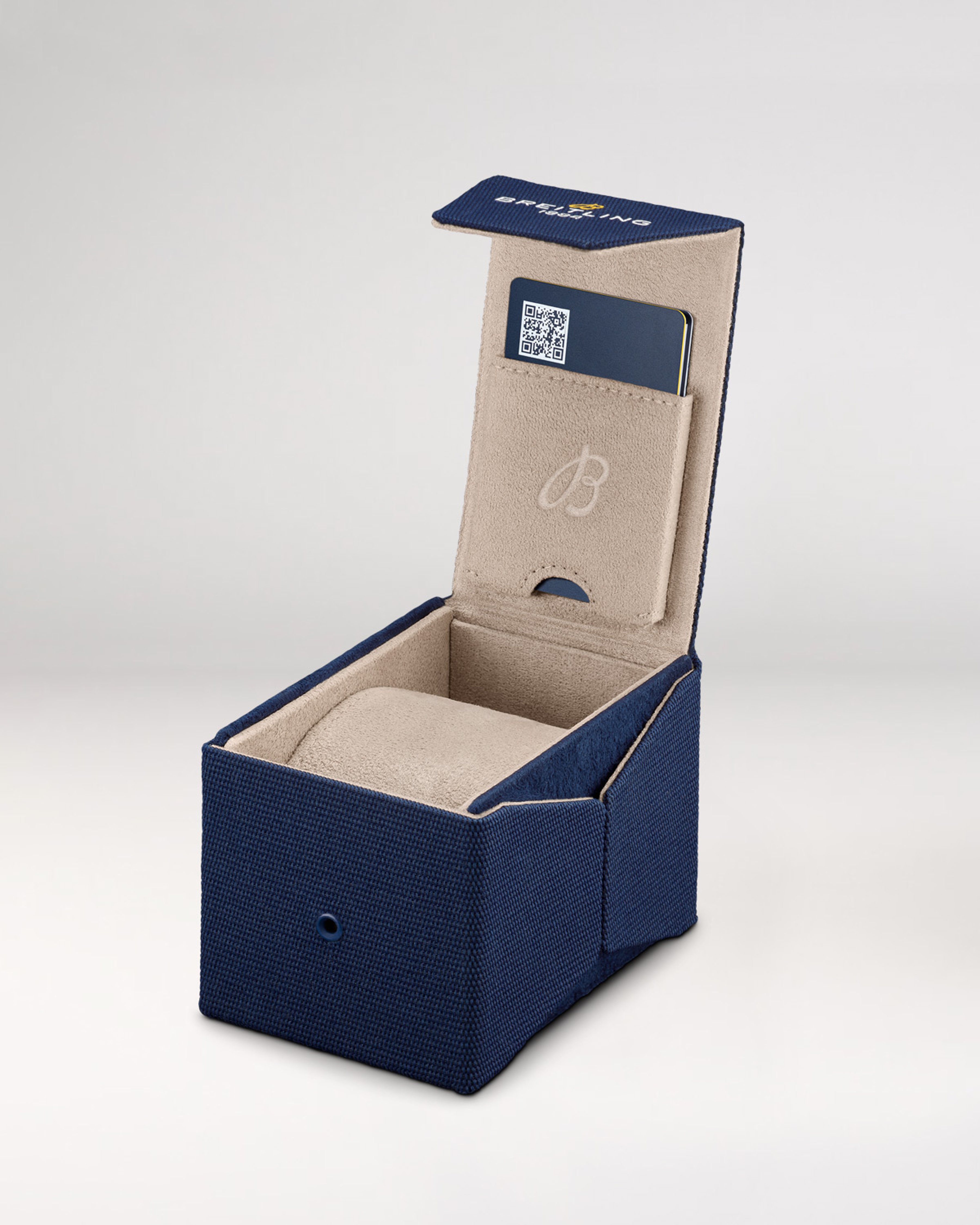 {generated} Breitling sustainable watch box in navy fabric with open lid, beige interior, card slot, and Efficient Solution label detail.