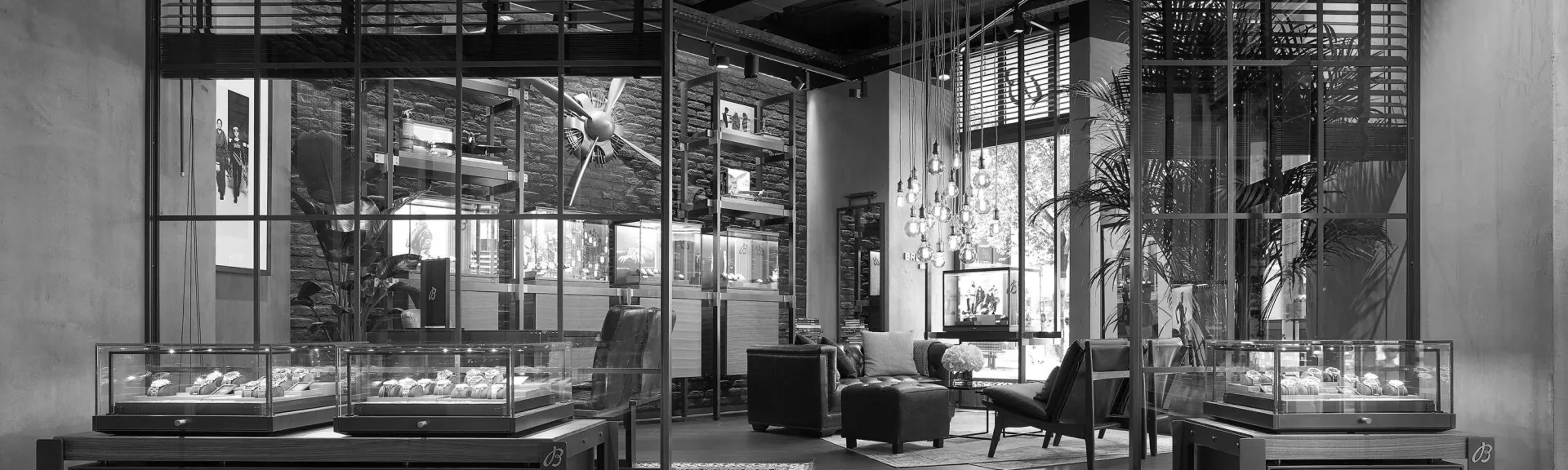 {generated} Elegant Breitling boutique interior with glass displays showcasing watch collections and refined seating near large windows.