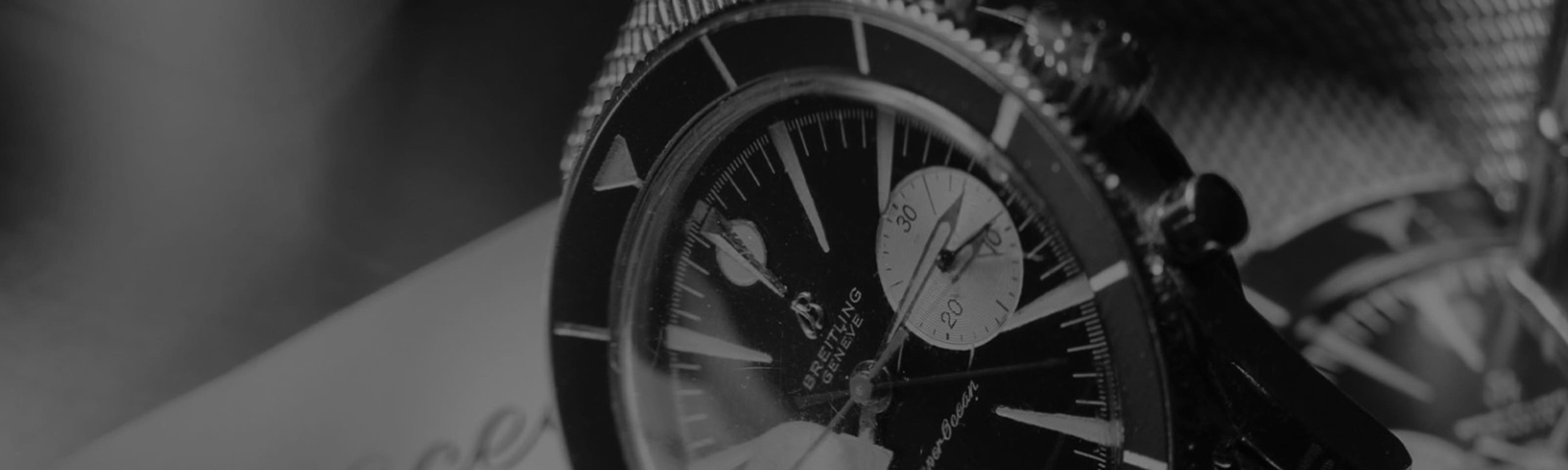 {generated} Primo piano della Breitling Superocean con quadrante scuro, indici decisi e bracciale in maglia mostrati con eleganza.