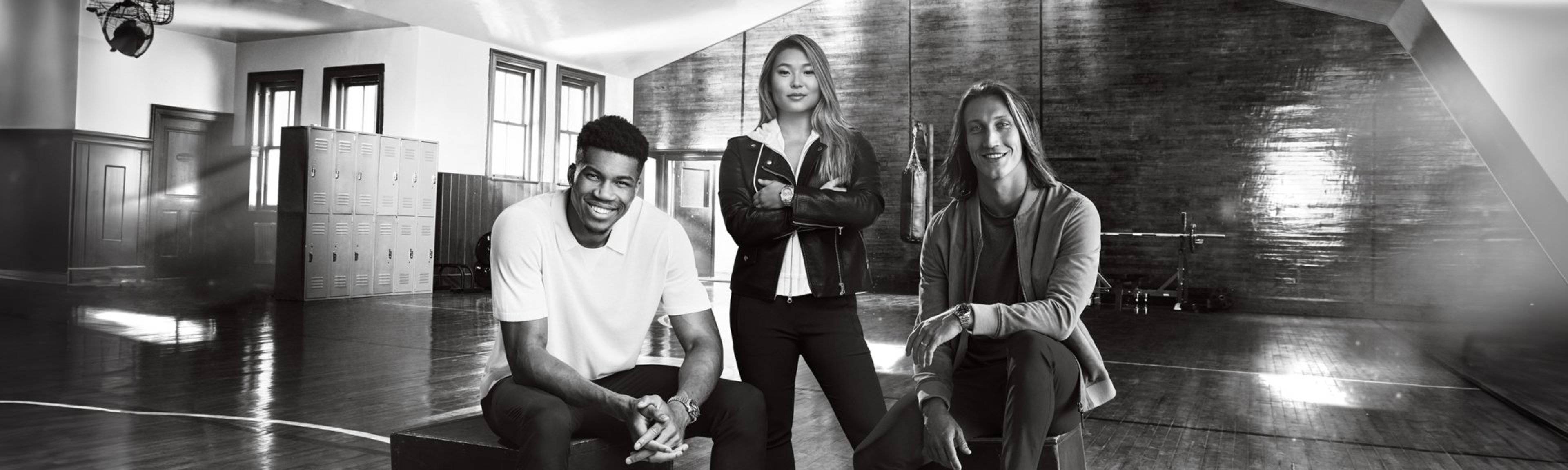 {generated} Three athletes in a vintage gym setting wearing Breitling Chronomat watches, presenting a confident sports‑inspired style.