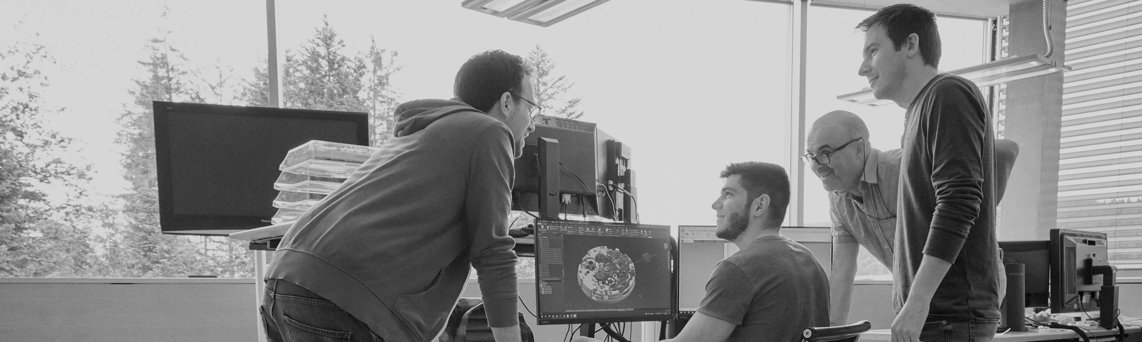 {generated} Engineers examine intricate digital schematics across several screens within a bright Breitling research and development space