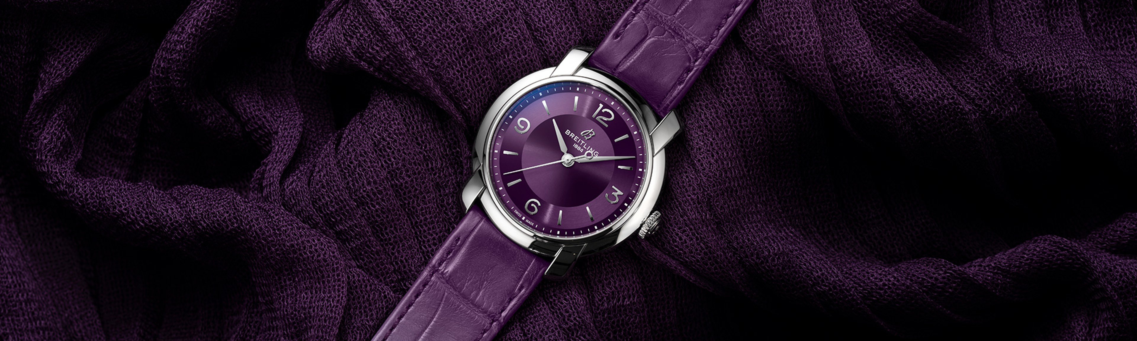 {generated} Breitling Lady Premier watch with a purple dial and leather strap displayed on rich textured violet fabric for a refined look