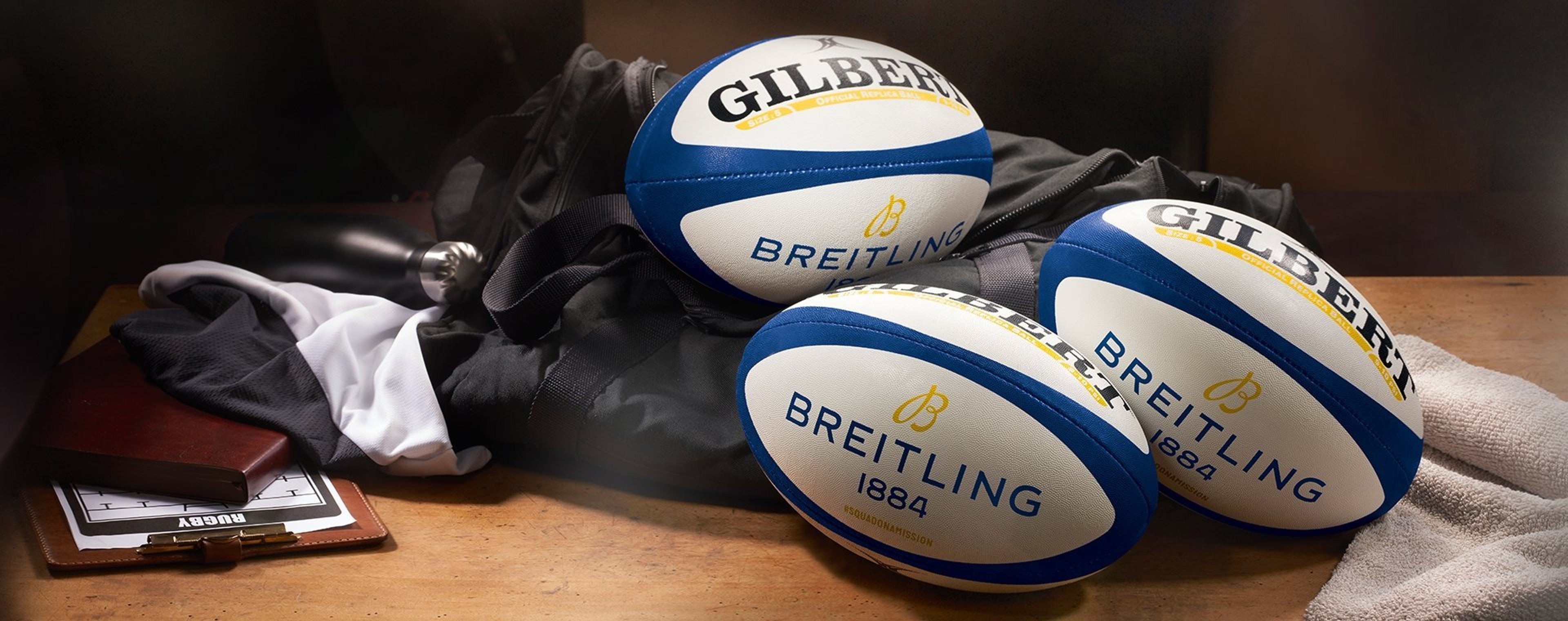 {generated} Breitling-branded rugby balls arranged with sports kit on a wooden surface, highlighting an exclusive gift offering