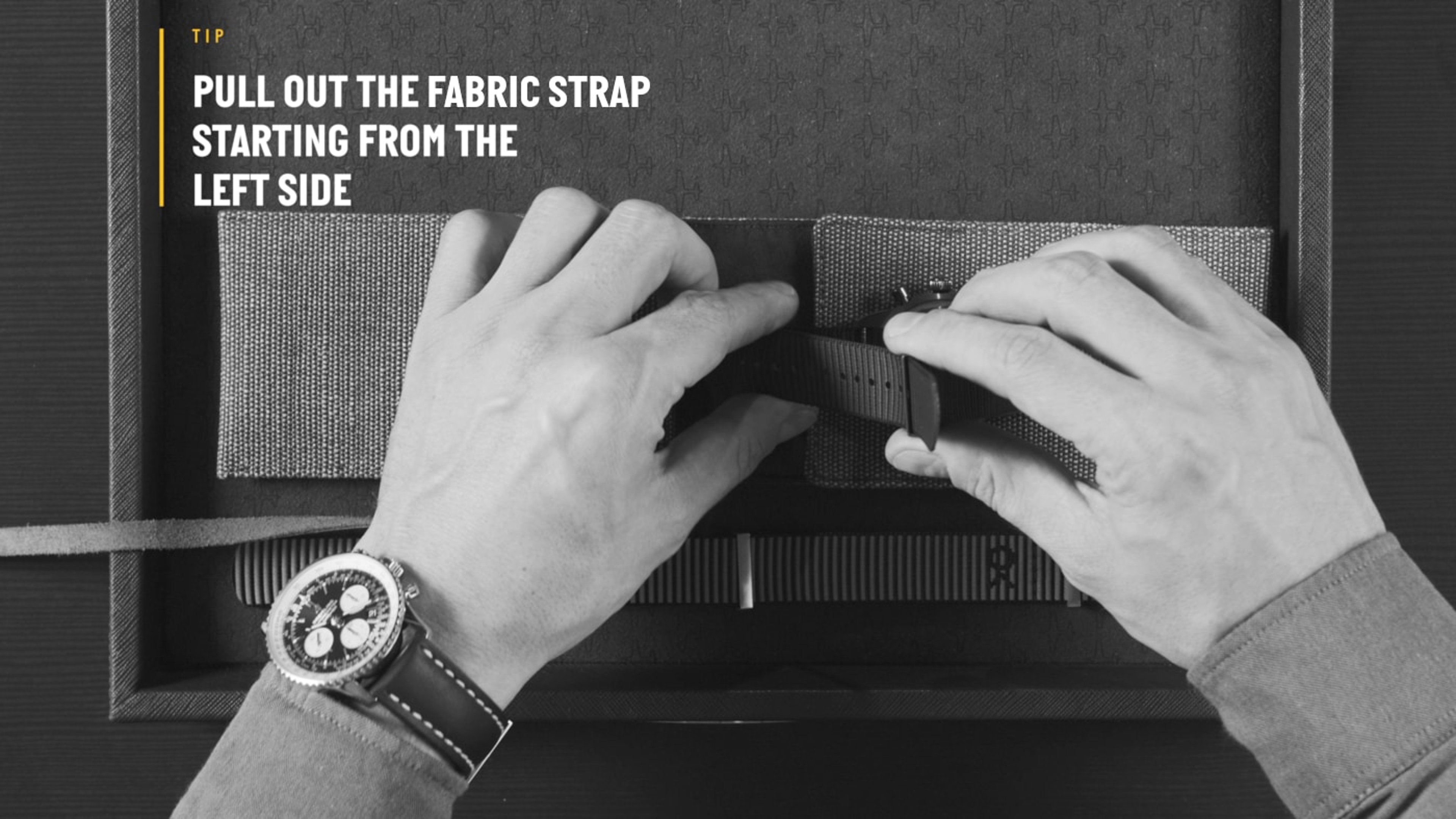 {generated} Hands remove a fabric strap from a case, with a visible Breitling watch worn as the process guides strap preparation.