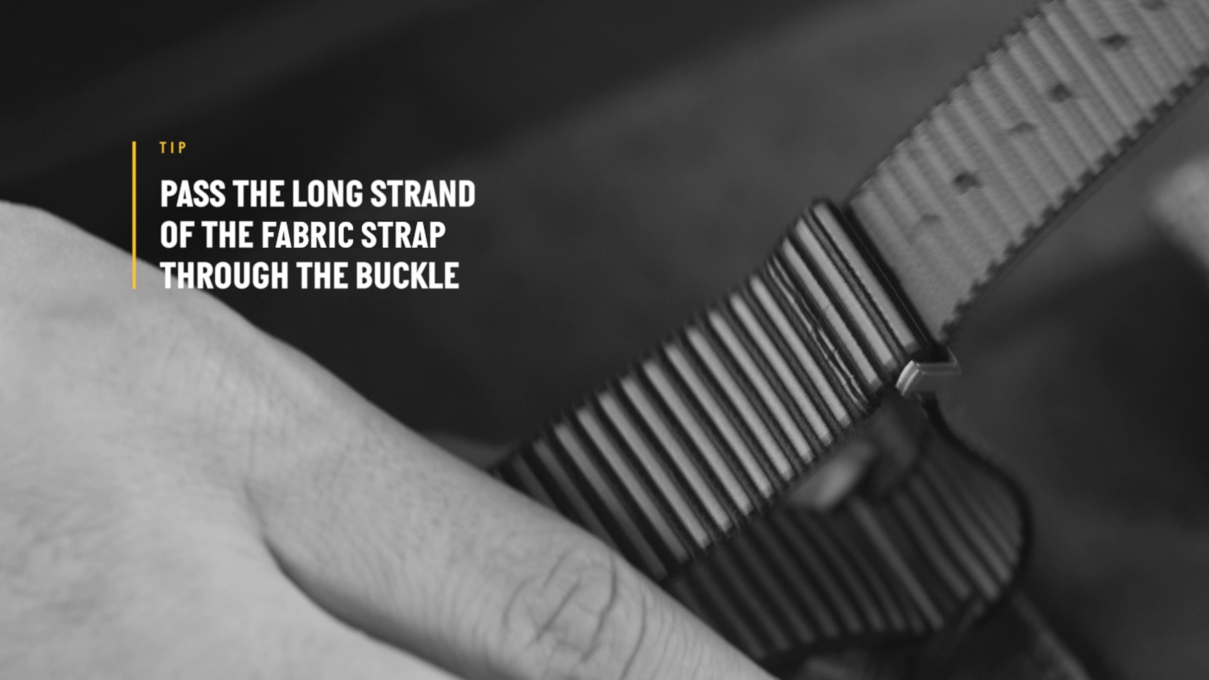 {generated} Hand guiding a Breitling fabric watch strap through its buckle, highlighting the detailed texture and precise fitting step.