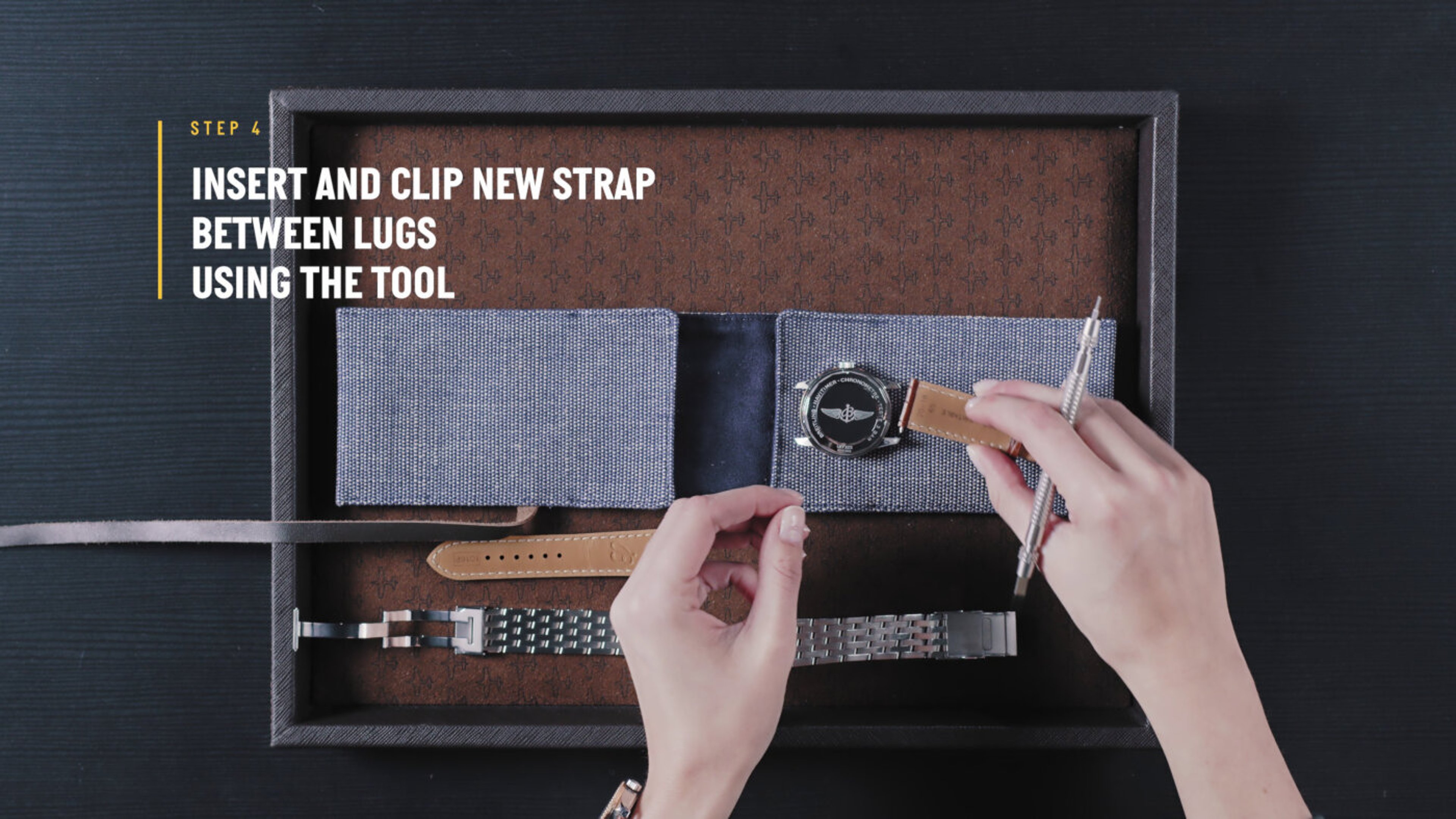 {generated} Hands fit a Breitling watch strap with a tool, guiding the leather piece between the lugs within a neatly arranged kit.