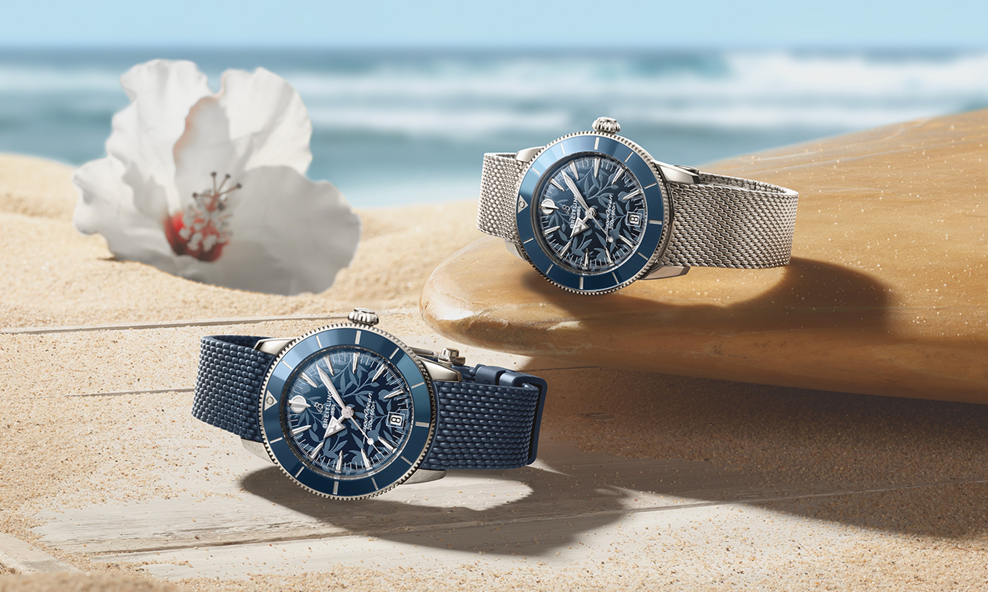 {generated} Breitling Superocean Heritage 2025 watches on sand and a surfboard with blue dials, evoking Kelly Slater’s ocean spirit