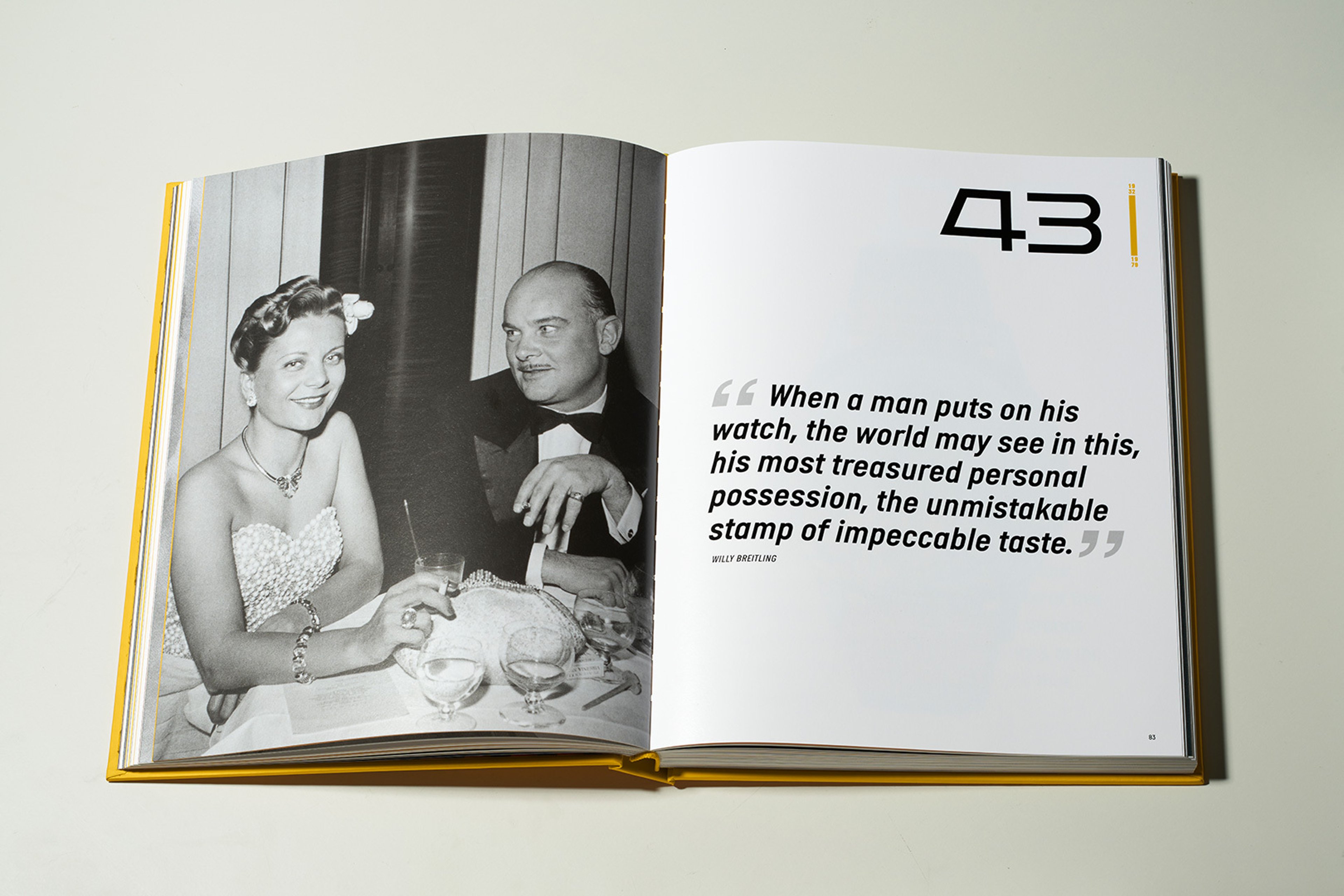 {generated} Open commemorative book with a vintage dining scene paired with a Willy Breitling quote highlighting refined taste.