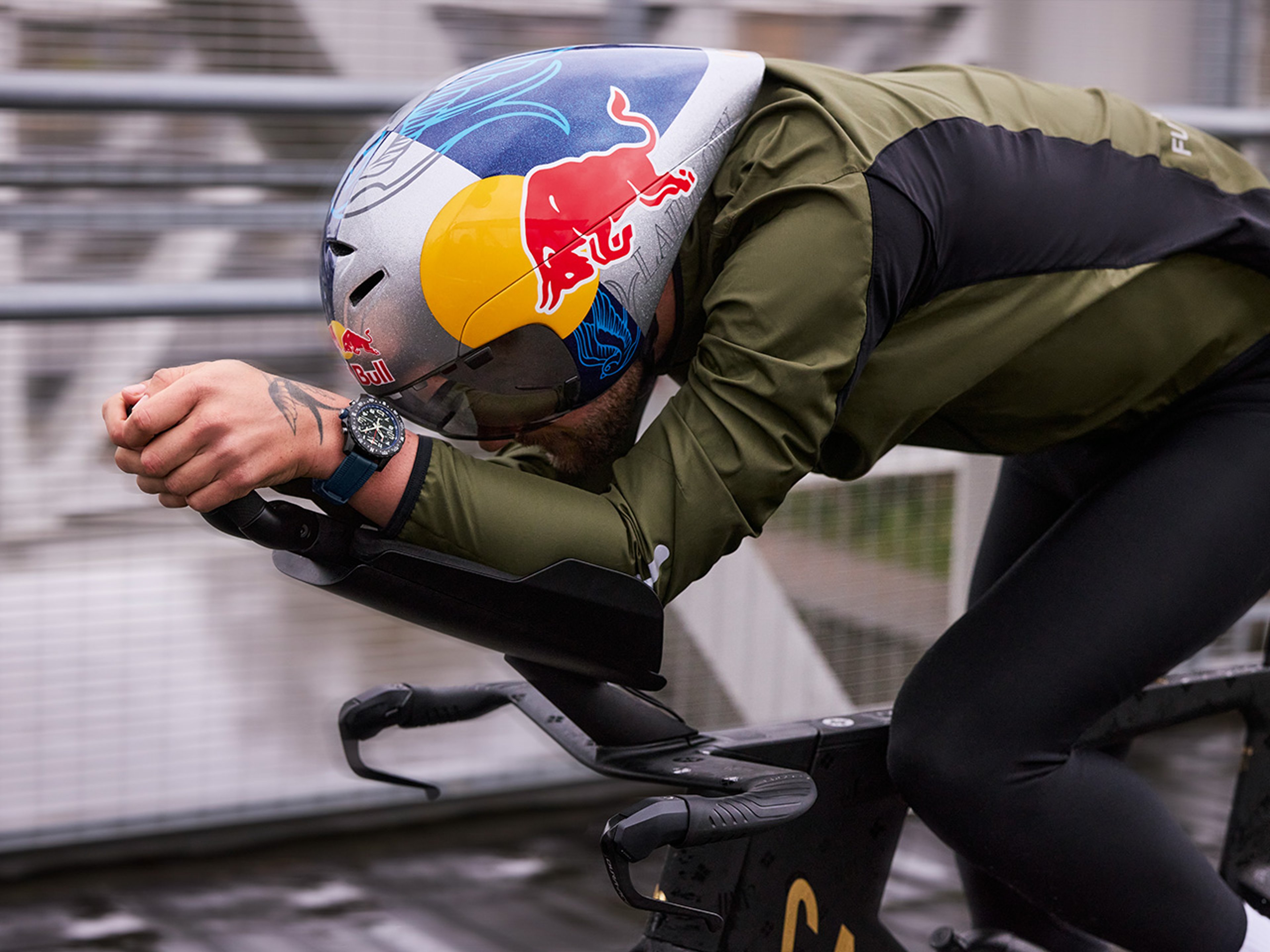 {generated} A cyclist in an aerodynamic stance with a vibrant helmet and a Breitling watch, capturing focused professional performance