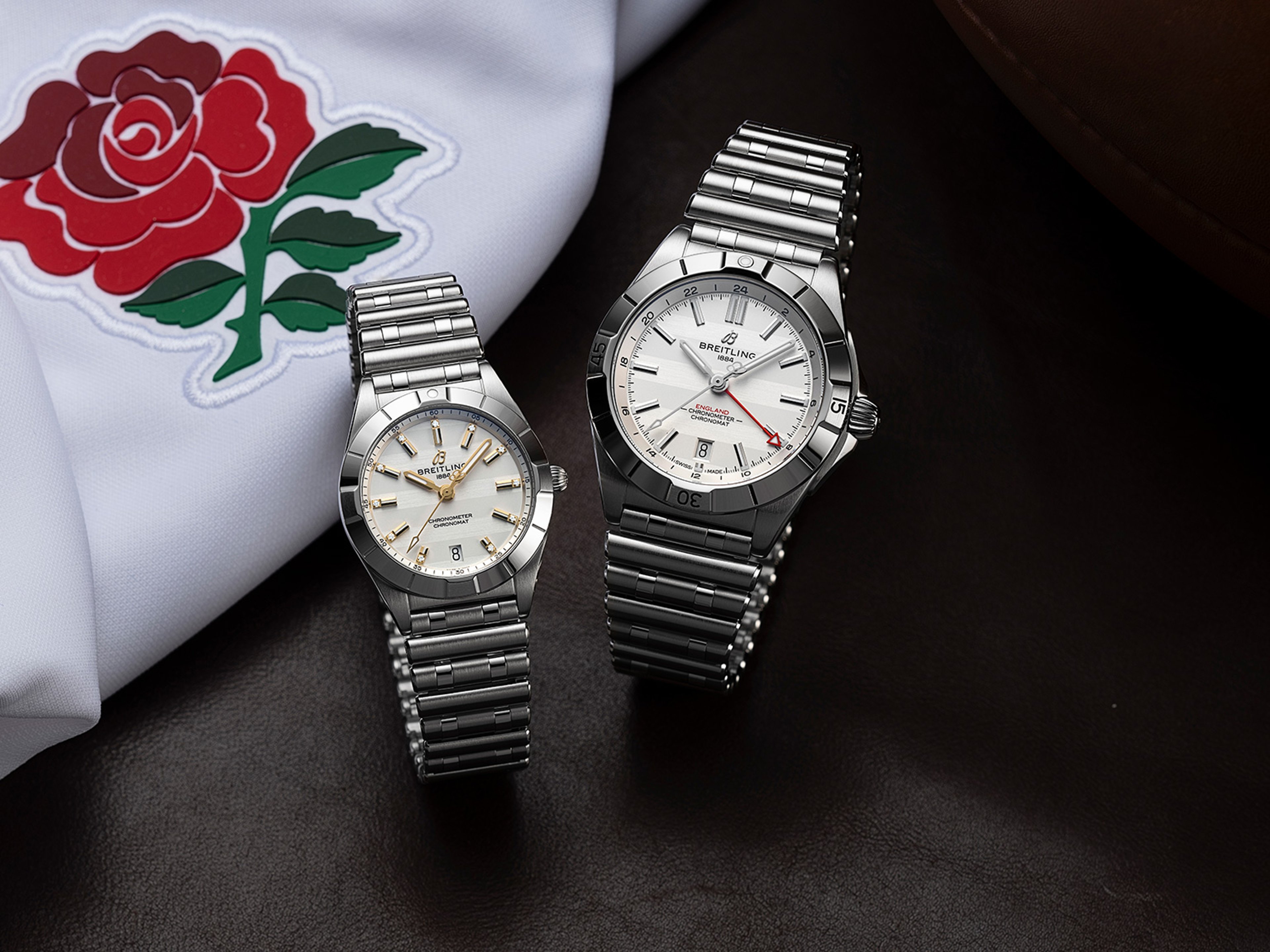 {generated} Two Breitling Chronomat England models displayed beside the England rose emblem, highlighting polished steel design.