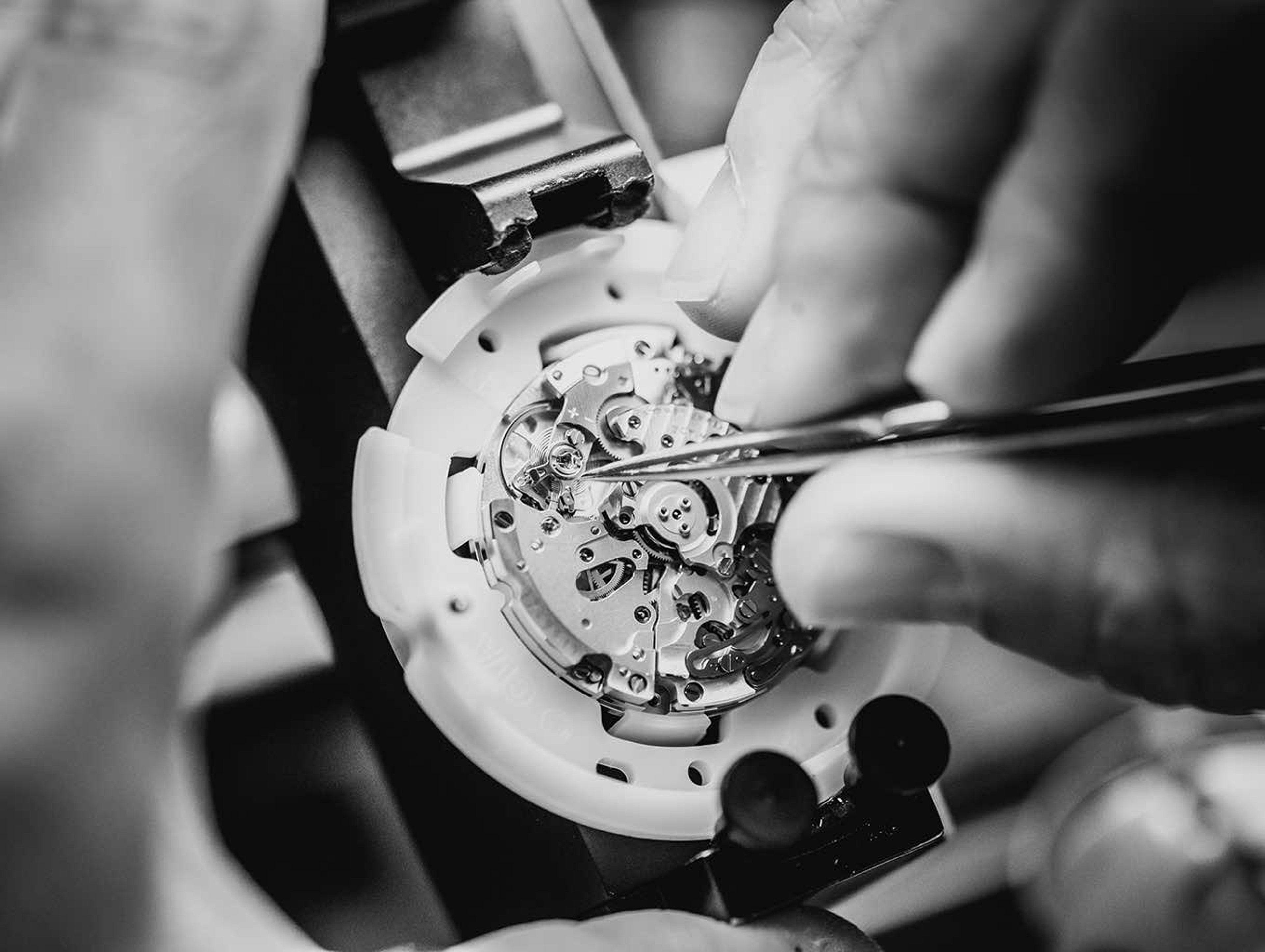 {generated} Breitling watchmaker adjusts an in‑house movement with fine tools, emphasising precision and advanced craftsmanship