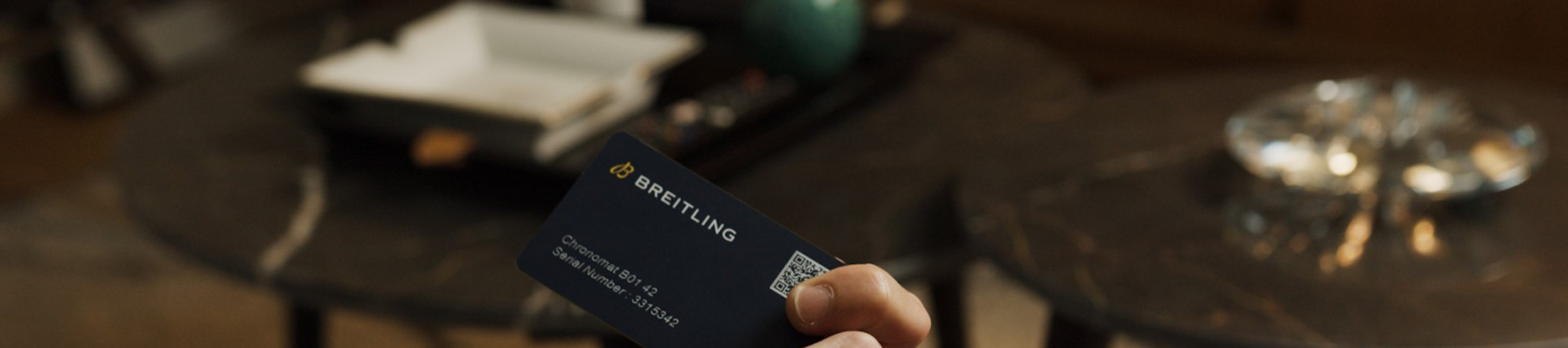 {generated} 雙手持Breitling數位護照卡並操作手機，強調安全的擁有權驗證。