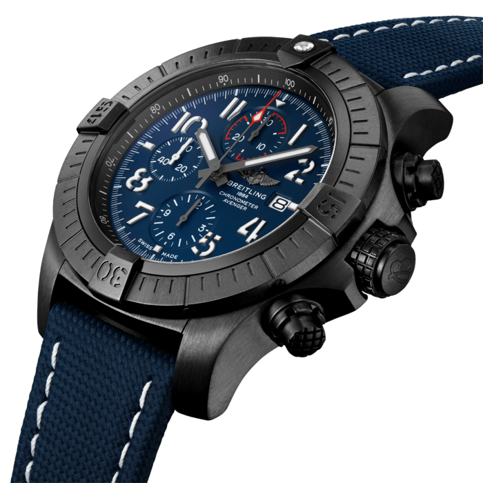Bold, extremely robust and shock resistant, the Super Avenger Chronograph 48 Night Mission makes a big “here I am” statement with its strong but lightweight case. As a true Breitling Avenger, it can be used wearing gloves and offers unrivalled safety and reliability to any airborne adventurer. The Night Mission interpretation of the Super Avenger Chronograph 48 features a sturdy oversized 48mm DLC-coated titanium case, blue dial and a blue military leather strap that fits either a DLC-coated stainless-steel pin buckle or folding clasp. Its specific Arabic numerals recall the stenciled numbers used on the decks of aircraft carriers. Thanks to its rugged bezel and its special grip-pattern on the crown & chronograph pushers, the Super Avenger Chronograph 48 Night Mission can be easily operated wearing gloves.