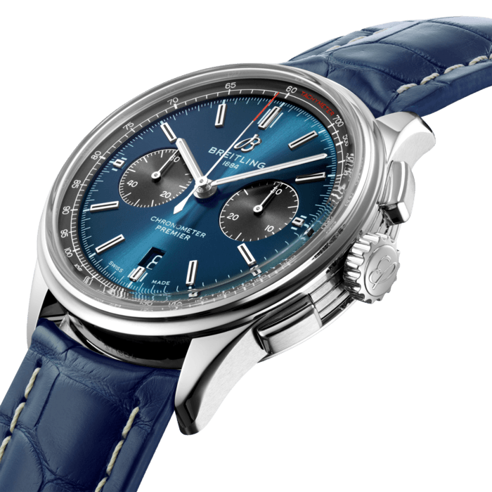 This elegant Premier chronograph features a 42 mm stainless steel case presented on a striking blue crocodile leather strap. Its striking blue dial is highlighted by contrasting black 30-minute and 12-hour chronograph counters. A transparent sapphire caseback reveals the self-winding high-performance chronometer-certified chronograph caliber, Breitling Manufacture Caliber 01, which is delivered with a five-year warranty. In addition to the version with the blue crocodile strap, this model is also available with a brown nubuck leather strap or a classic seven-row stainless steel bracelet. Elegance and performance worthy of the Breitling Premier name.