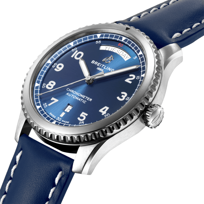 The Aviator 8 Day & Date 41 prominently displays the day of the week and the date along with the time. The day of the week is indicated at the 12 o’clock position while the date is ideally placed at 6 o’clock. Powered by the Breitling Caliber 45, this automatic wristwatch has a bidirectional rotor winding with over 40 hours of power reserve. The dial, in black or blue, is revealed through a double anti-reflective sapphire glass. The 41 mm steel case has a solid screwed back. It comes with a steel bracelet or a leather strap.