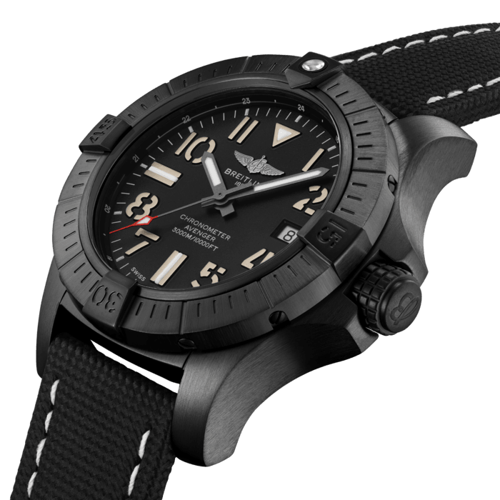 Bold, extremely robust and shock resistant, the Avenger Automatic 45 Seawolf is a lightweight pilots’ watch prepared for adventures well below the ocean’s surface (up to 300 bars - 3.000m). As a true Breitling Avenger, it can be used wearing gloves and offers unrivalled safety and reliability to any airborne adventurer. The Night Mission interpretation of the Avenger Automatic 45  Seawolf features a sturdy 45mm DLC-coated titanium case, black dial and a black military leather strap that fits either a DLC-coated stainless-steel pin buckle or folding clasp. Its specific Arabic numerals recall the stenciled numbers used on the decks of aircraft carriers. With an impressive water resistance, the Seawolf is at ease up in the air and deep down the oceans. Thanks to its rugged bezel and its special grip-pattern on the crown, the Avenger Automatic 45 Seawolf Night Mission can be easily operated wearing gloves.