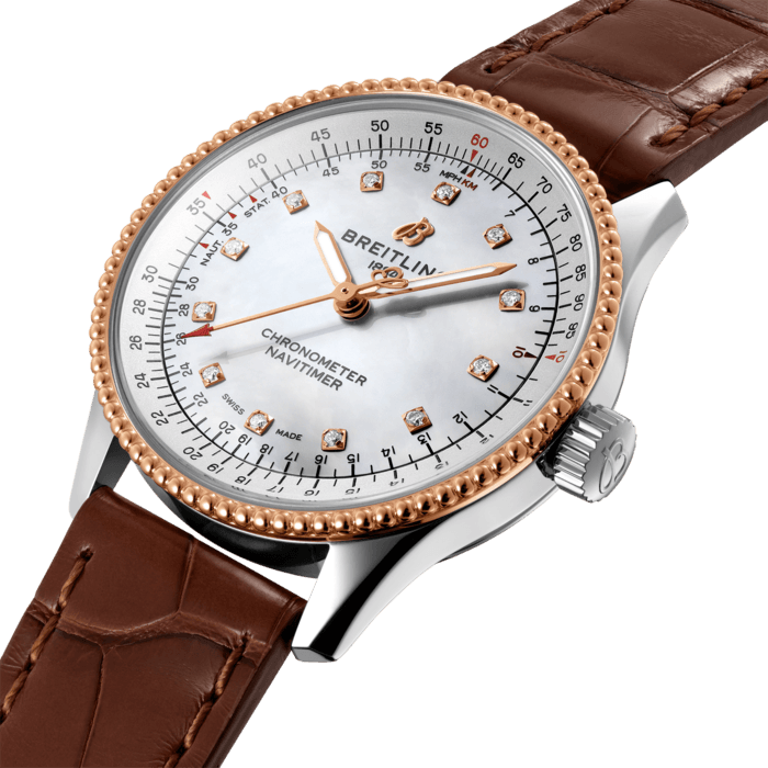 Refined and elegant, the Navitimer Automatic 35 combines the historic appeal of a true icon with the sophistication of a contemporary timepiece.
Available in a variety of materials including stainless steel and 18k red gold, the 35 mm case features a beaded bezel and a range of elegant dial colors, as well as diamond-set white mother of pearl. Offered either with a matching bracelet or alligator strap that fits both a stainless steel pin or folding buckle, the Navitimer Automatic 35 is powered by the Breitling Caliber 17, a COSC-certified chronometer.