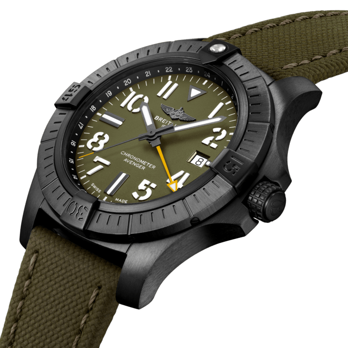 Bold, extremely robust and shock resistant, the Avenger Automatic GMT 45 Night Mission features a lightweight case and an additional yellow hand indicating a second time zone. As a true Breitling Avenger, it can be used wearing gloves and offers unrivalled safety and reliability to any airborne adventurer. Limited to 2000 pieces.
The Night Mission interpretation of the Avenger Automatic GMT 45 features a sturdy 45mm DLC-coated titanium case, green dial and a green-colored military leather strap that fits either a DLC-coated stainless-steel pin buckle or folding clasp. Its specific Arabic numerals recall the stenciled numbers used on the decks of aircraft carriers. Thanks to its rugged bezel and its special grip-pattern on the crown, the Avenger Automatic GMT 45 Night Mission can be easily operated wearing gloves.