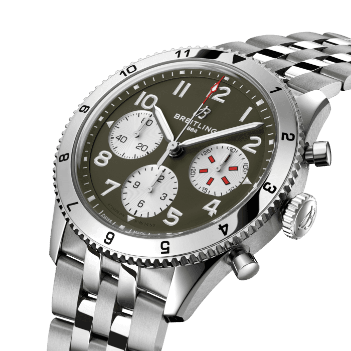 From brave first takeoffs to the birth of commercial air travel, Breitling’s history is inseparable from that of flight. In the 1930s, Breitling’s Huit Aviation department made its name inventing precision cockpit clocks. Two decades later, it introduced yet another novel flight instrument, this time in wearable form: the Ref. 765 AVI. That pioneering pilot’s watch provided the technical backdrop for today’s Classic AVI, a collection inspired by the rugged spirit of famed early aircraft.
The Classic AVI Curtiss P-40 Warhawk honors one of those legends. Conceived as a pursuit aircraft, the Curtiss P-40 Warhawk first flew in 1938 and quickly proved itself as a master of agility. It wasn’t just the plane’s capacity for pulling jaw-dropping turns that gave it an in-flight edge, its robust structure meant it could tolerate harsh weather conditions and even many mid-air collisions. The Warhawk’s defiant shark-mouth nose art sealed its reputation as the rebel of the skies.
As a true pilot’s watch designed to withstand the rigors of a vintage cockpit, the Classic AVI Curtiss P-40 Warhawk features large, highly legible Arabic numerals on the dial and bezel.
The knurled bezel on the 42mm case provides optimal grip, even in a pilot’s gloved hands. Top-stitched calfskin straps give a nod to the seams found on classic flight gear, while the stainless-steel bracelet provides an elegant alternative. Pilots and other travelers will appreciate its legibility, wearability, and understated style. The engine of the Classic AVI is the COSC-certified Breitling Caliber 23 movement, which provides approximately 48-hours of power reserve.